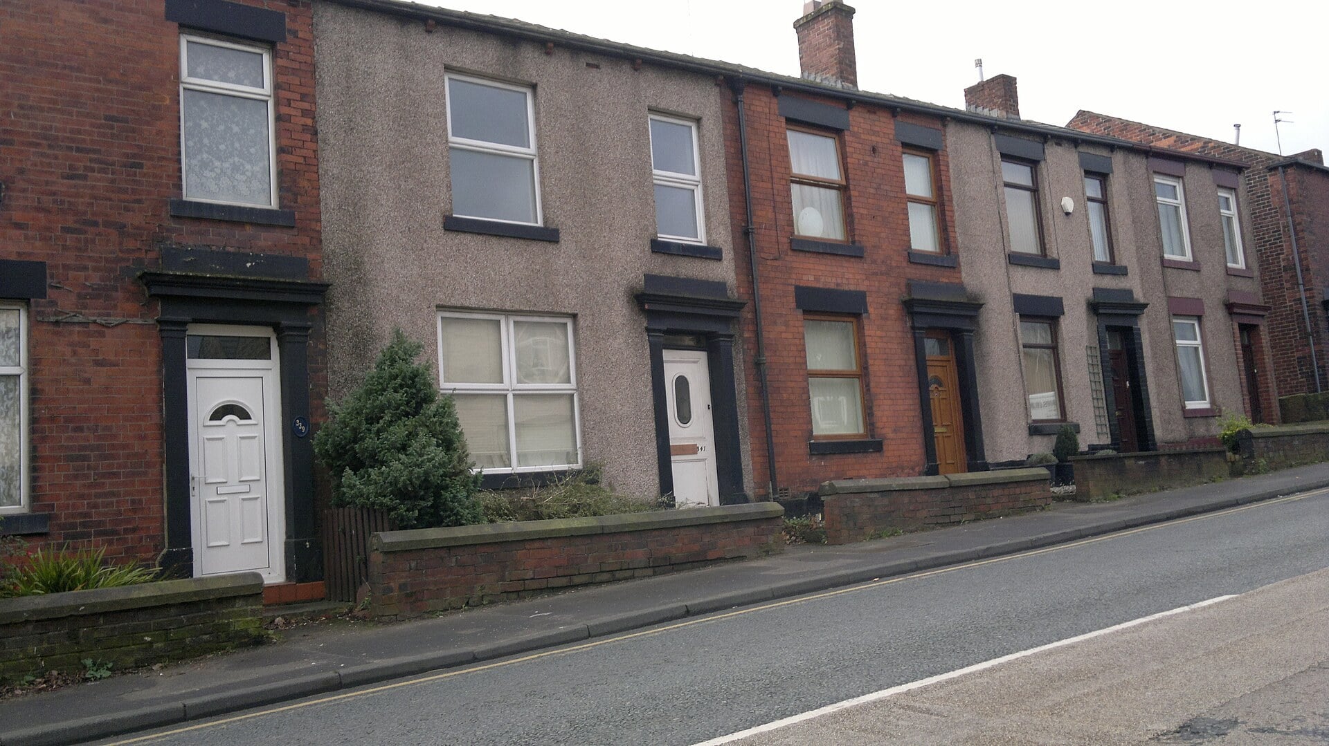 Red brick terraced houses with slate roofs in Rochdale