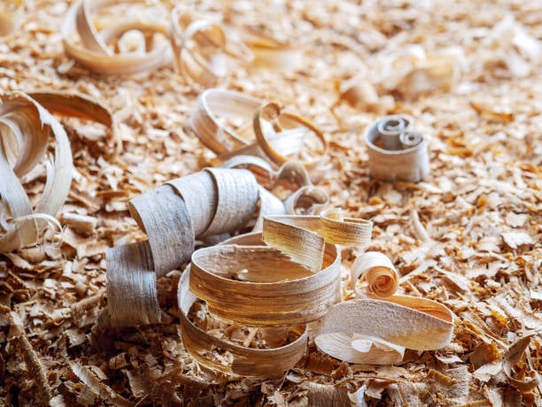 Close-up of sawdust and wood shavings used as raw feedstock for composite manufacturing