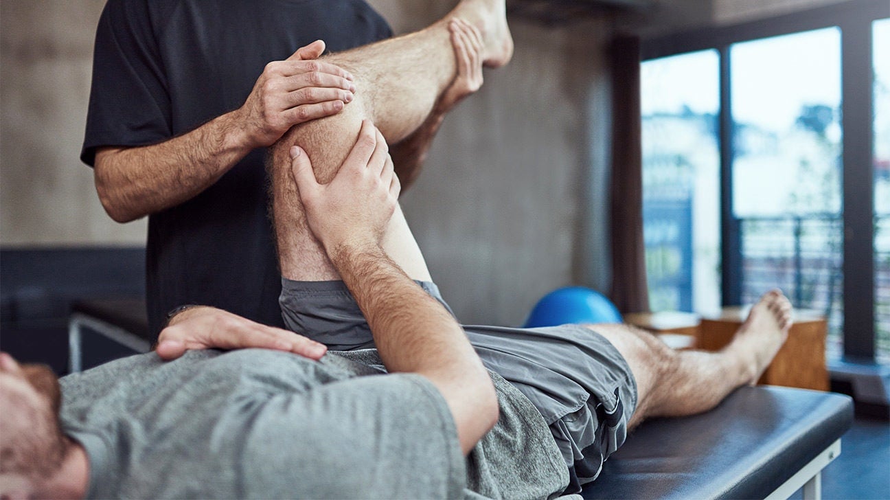 Patient performing rehabilitation movement exercises with therapist guidance