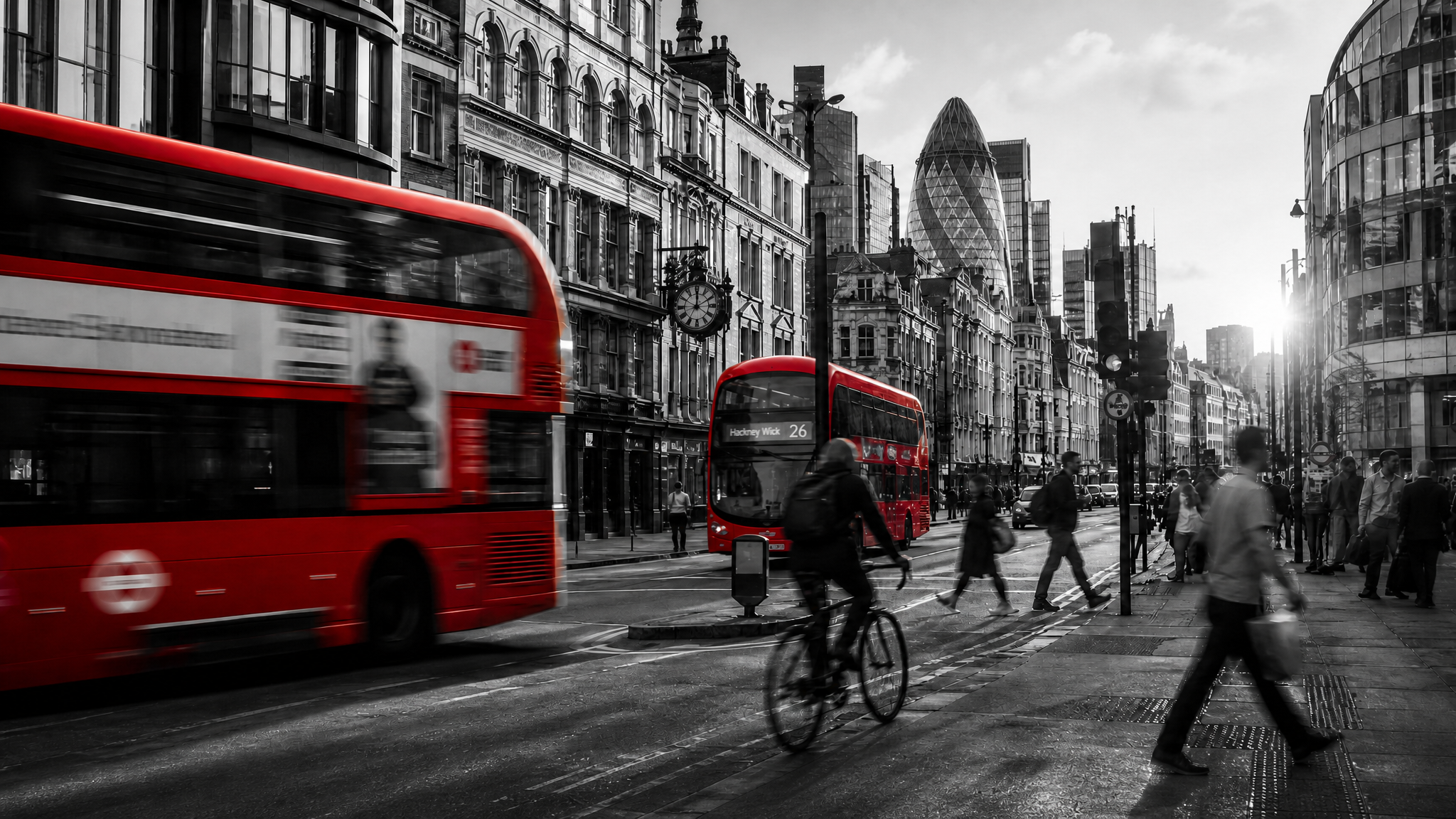 Busy London street with red buses and historic architecture