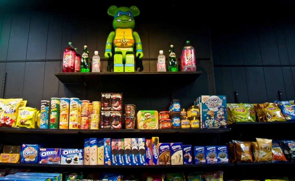 Bodega shelves stocked with snacks, chips, and prepackaged food items