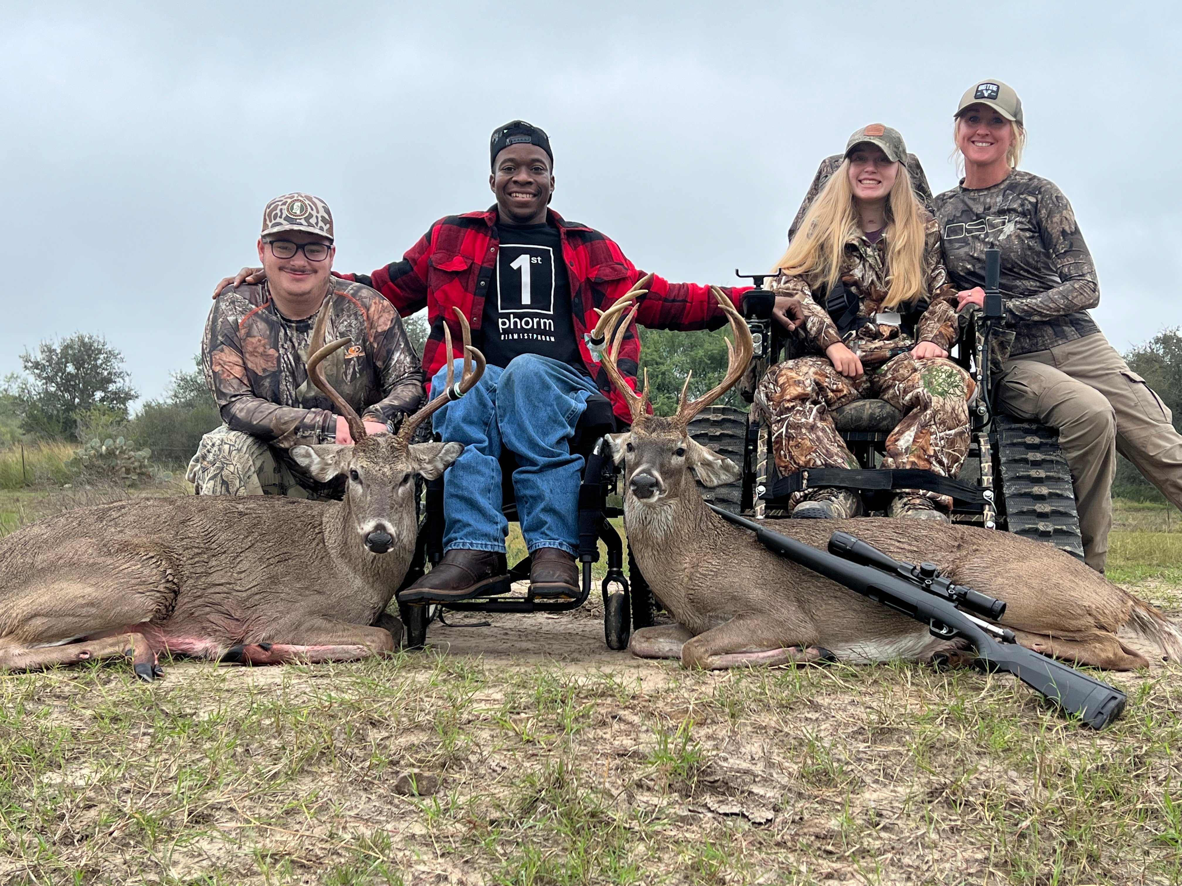 Group of four hunters with two whitetail bucks on a Texas ranch