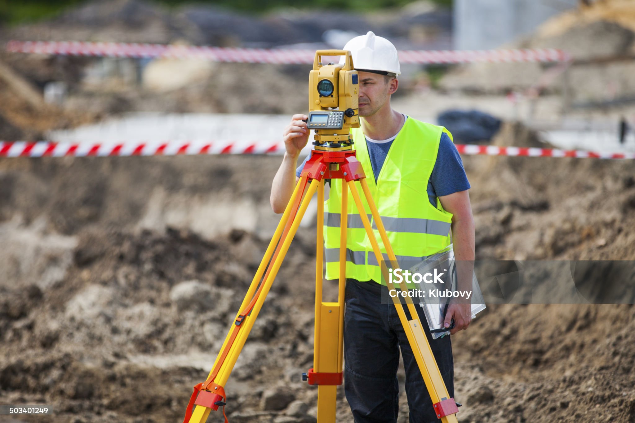 Land surveyor with equipment on development site