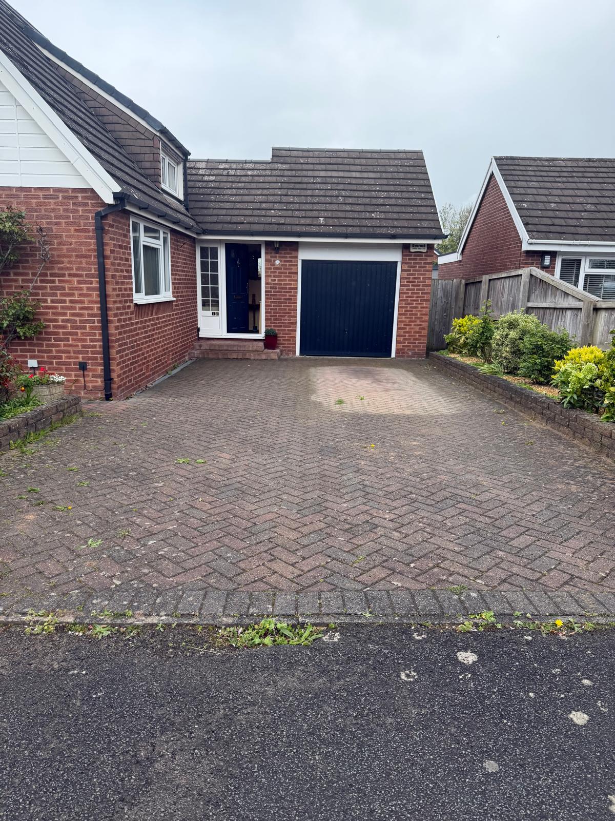 Completed herringbone block-paved driveway at red-brick bungalow