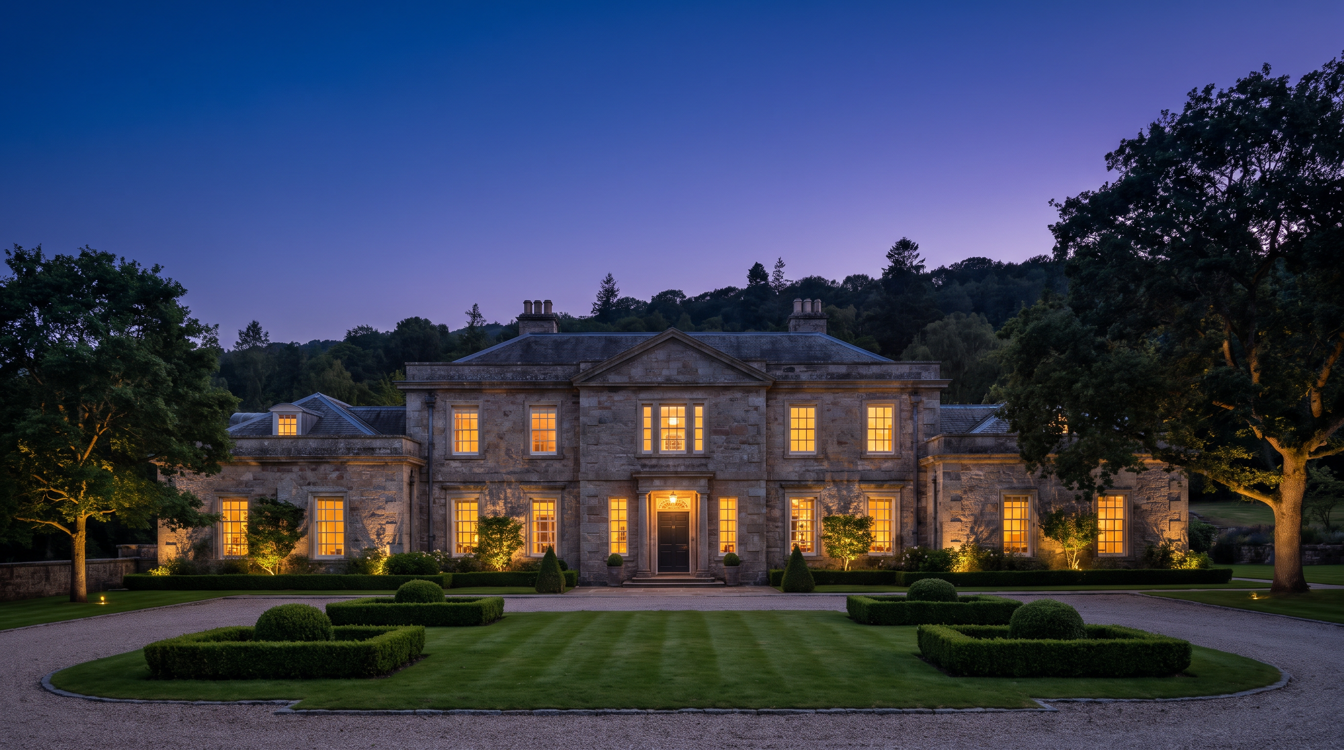 A stately family home at dusk