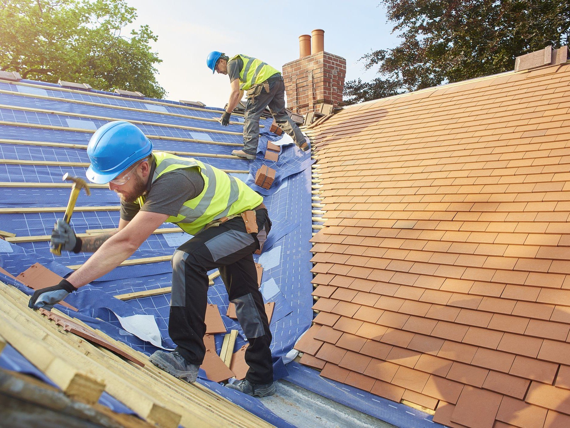 Professional roofers at work on a UK home