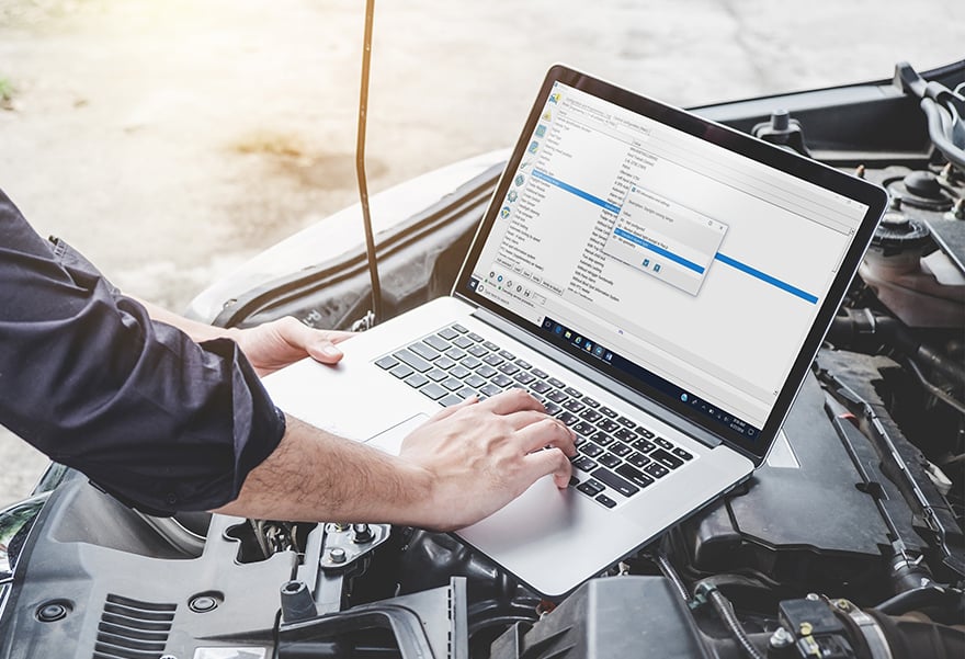 Technician performing hybrid vehicle diagnostics