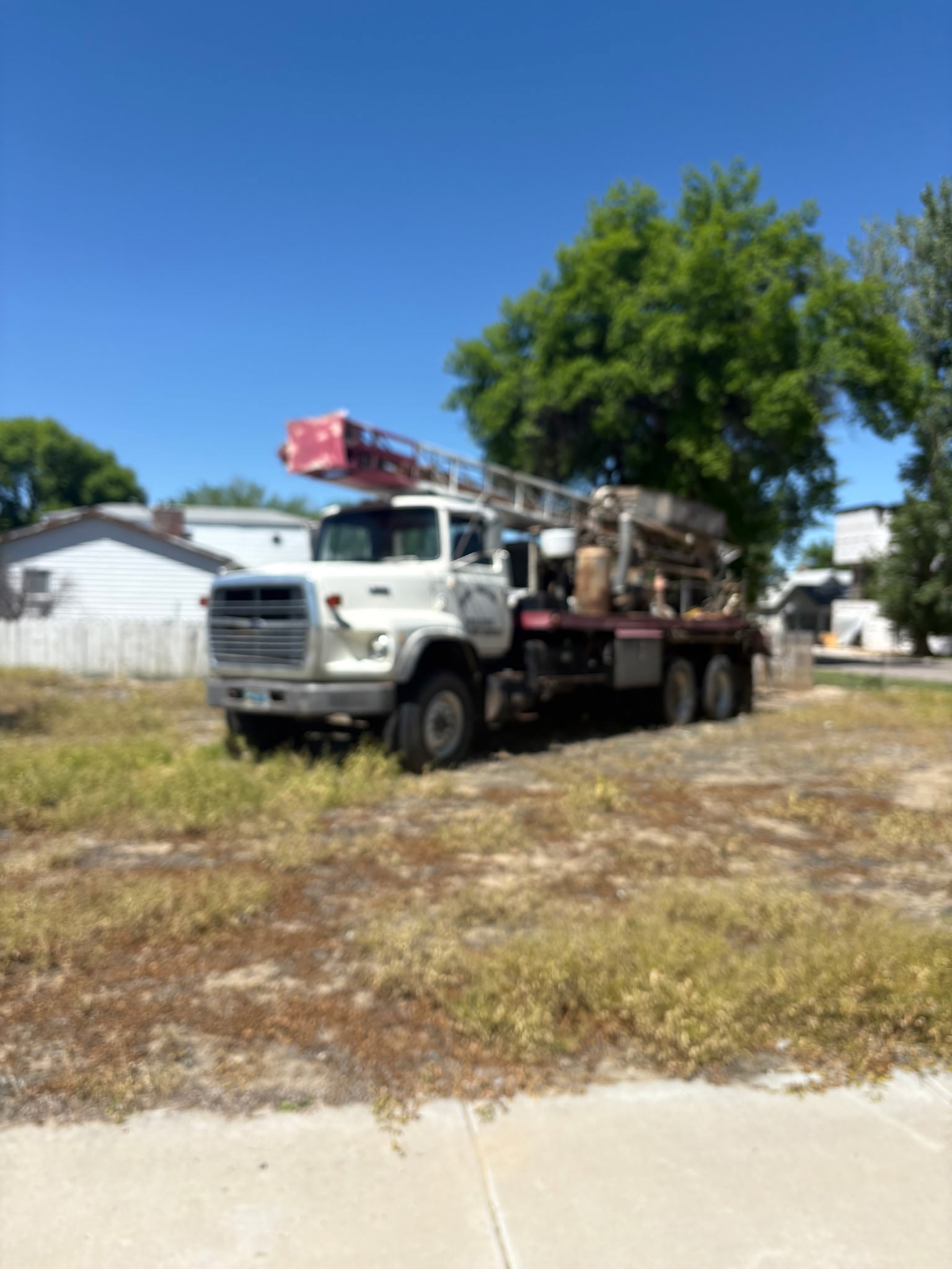Wyoming Water Wells drilling truck on a residential property