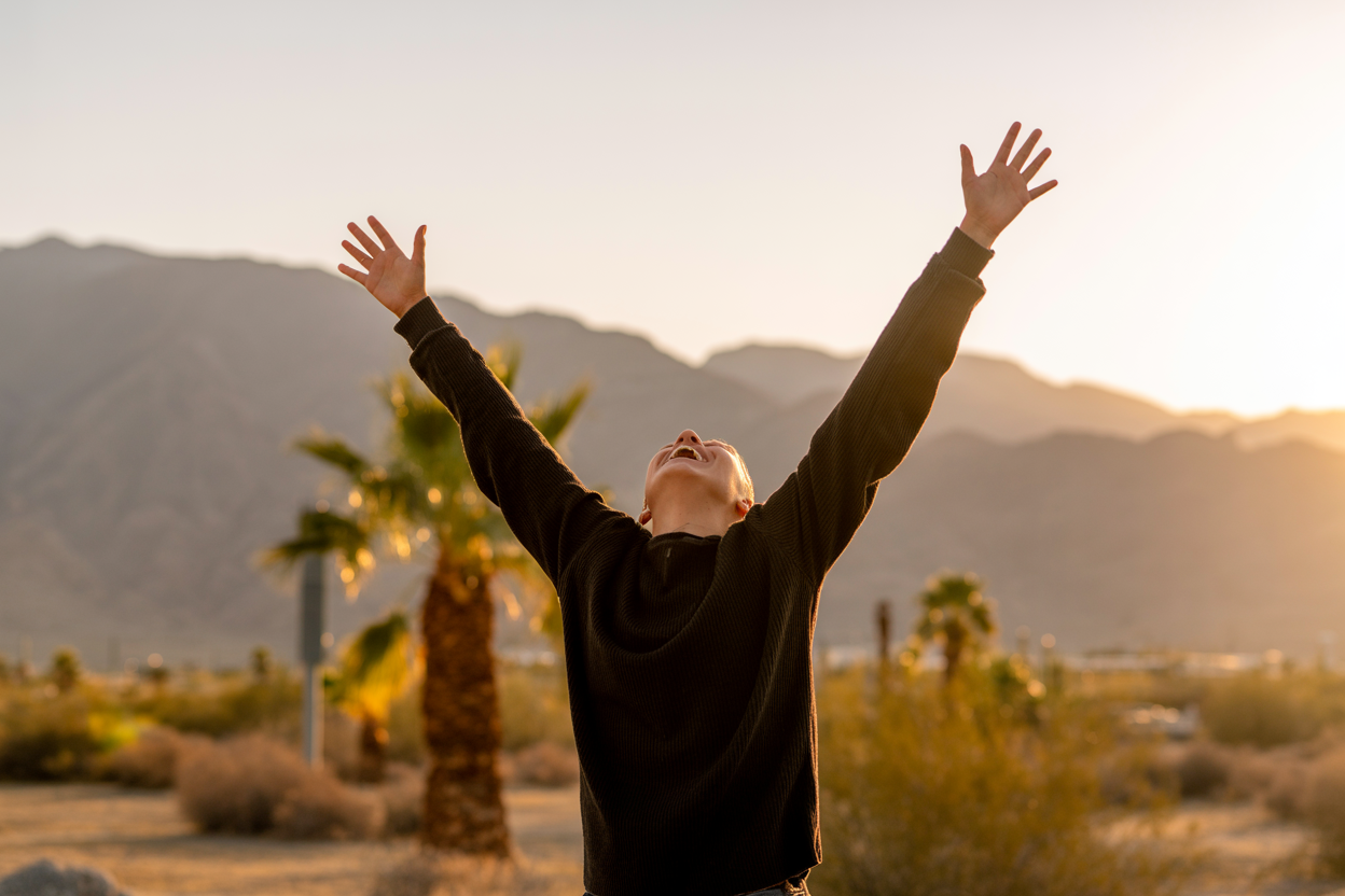 Person with arms raised in gratitude