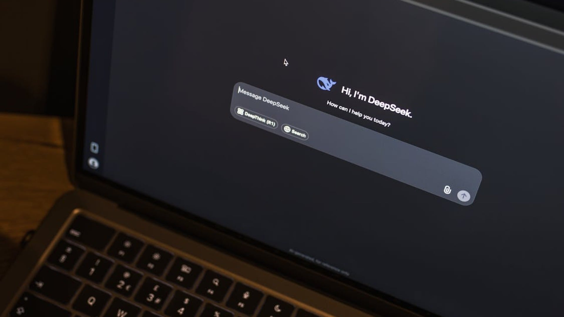 Business professional using AI chat interface on laptop