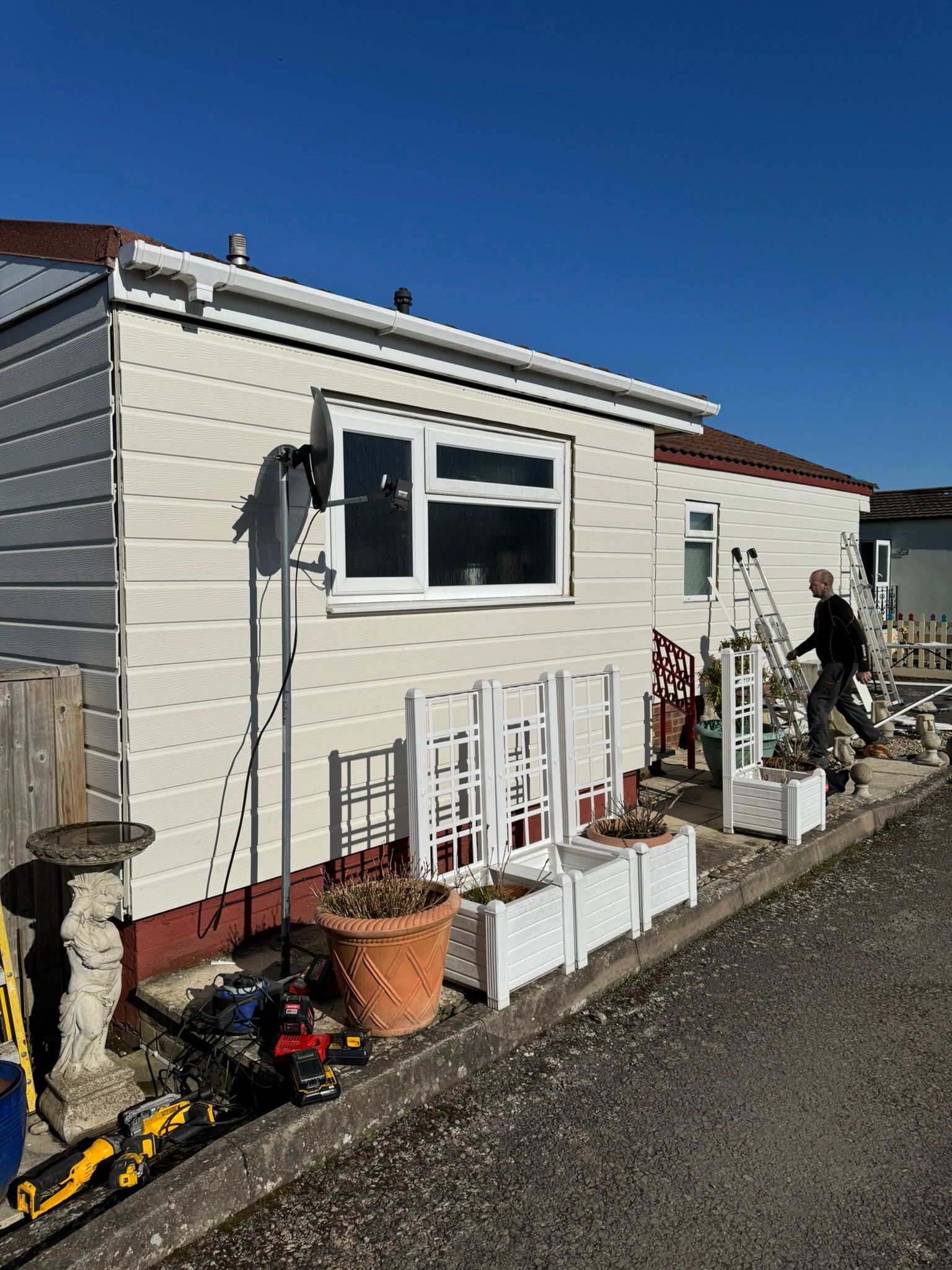 Completed park home exterior with new cream cladding and white guttering