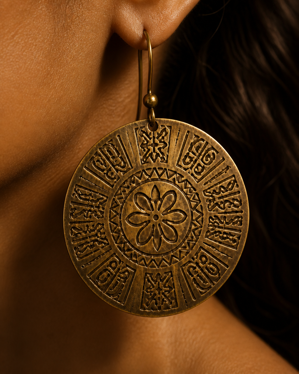 Close-up of the Accra Disc earring by a model's ear