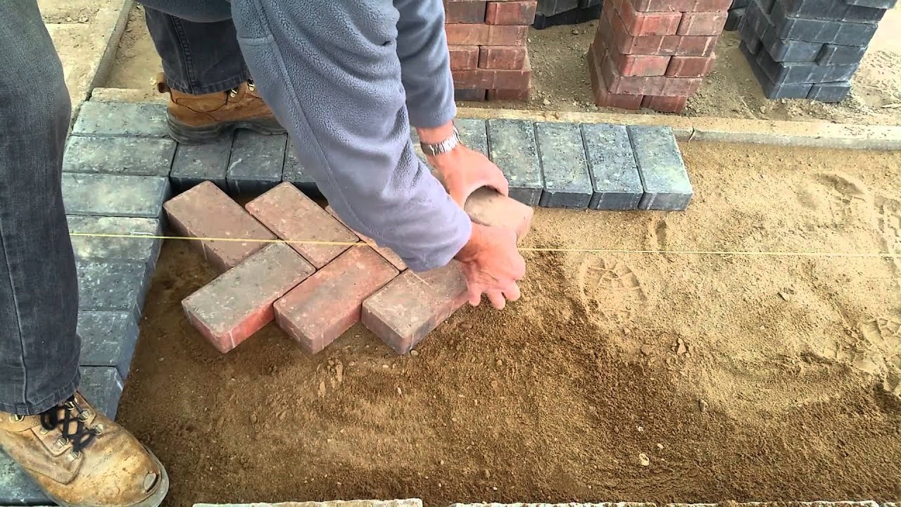 Herringbone pattern block paving being professionally laid