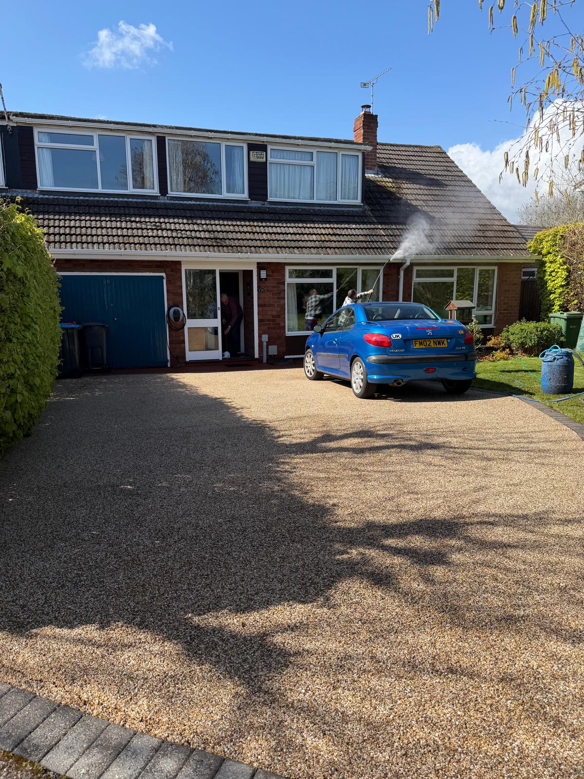 Operative steam cleaning moss off pitched tiled roof