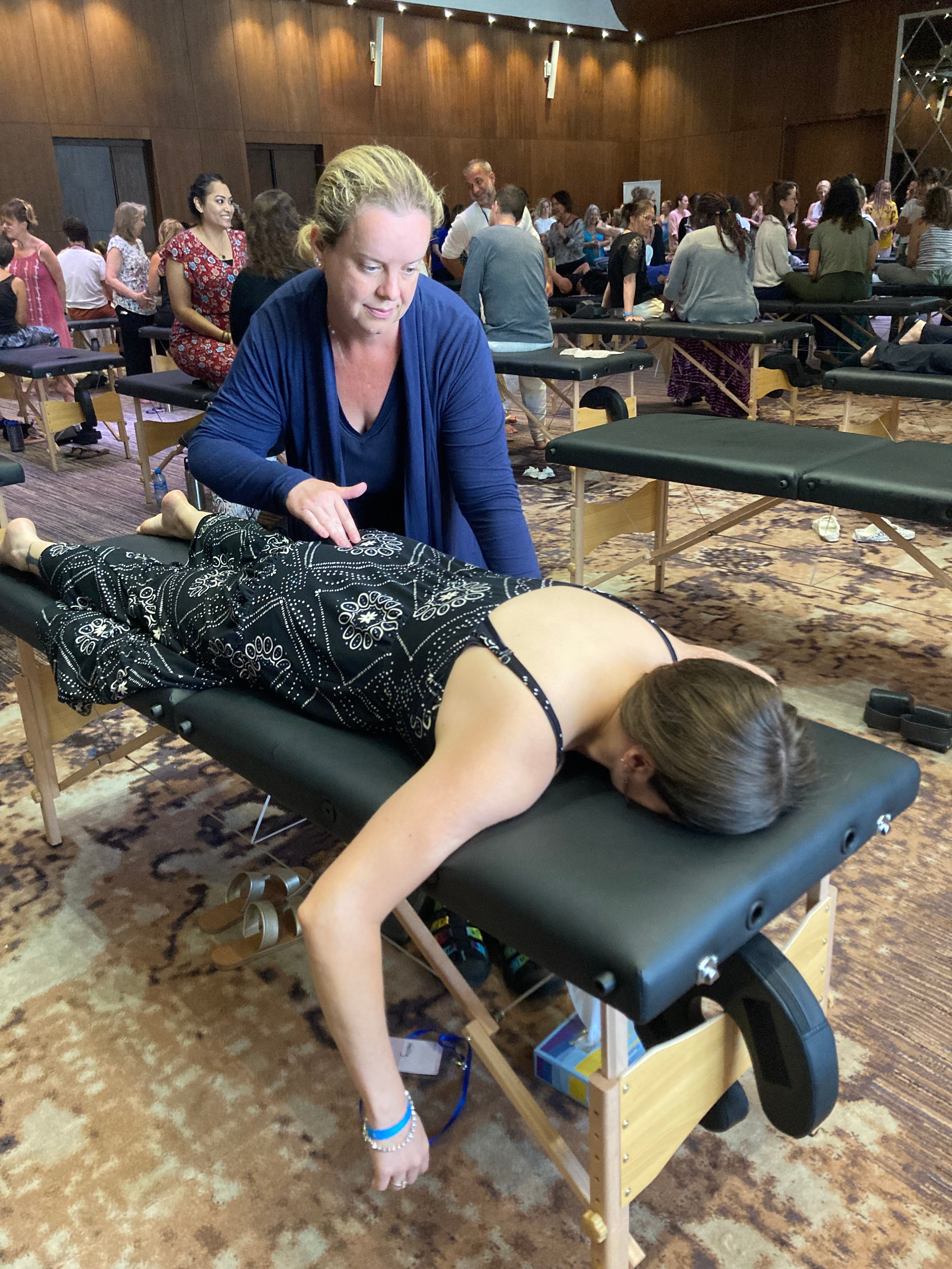 Sarah smiling while working with a client at the Spinal Flow immersive in Mexico