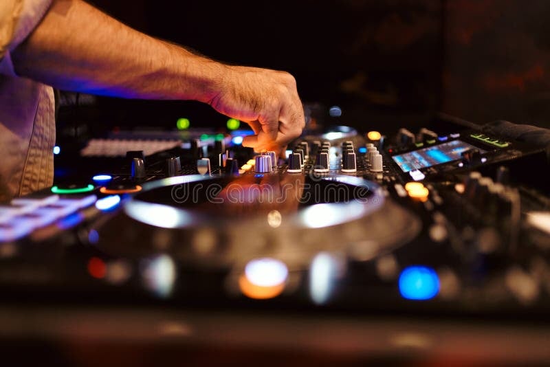 DJ hands mixing on turntables close up