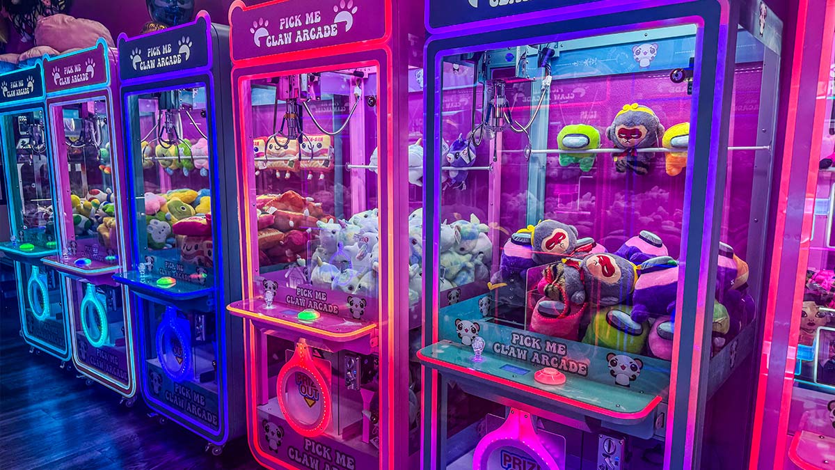 Colorful arcade claw machine showcasing amusement device rentals
