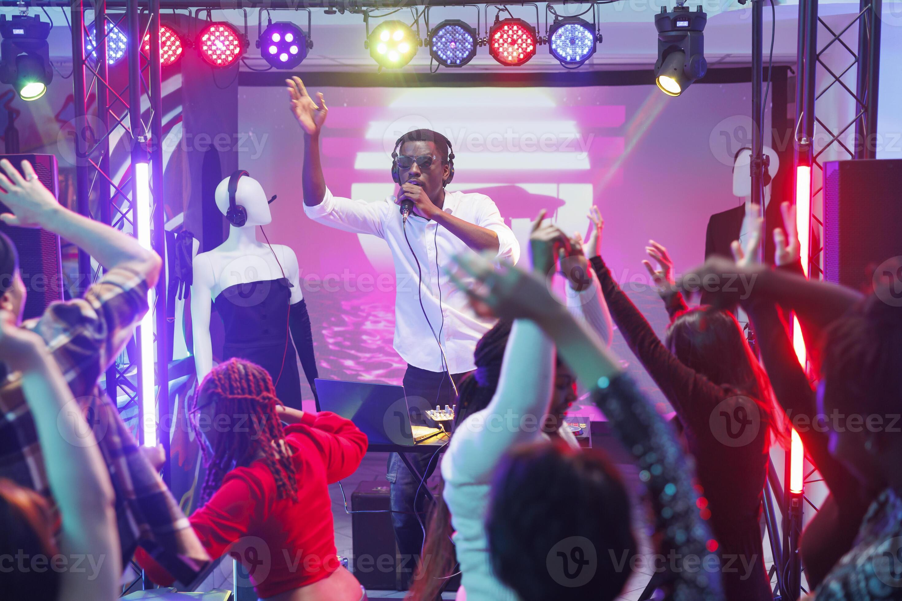 DJ performing on stage with crowd