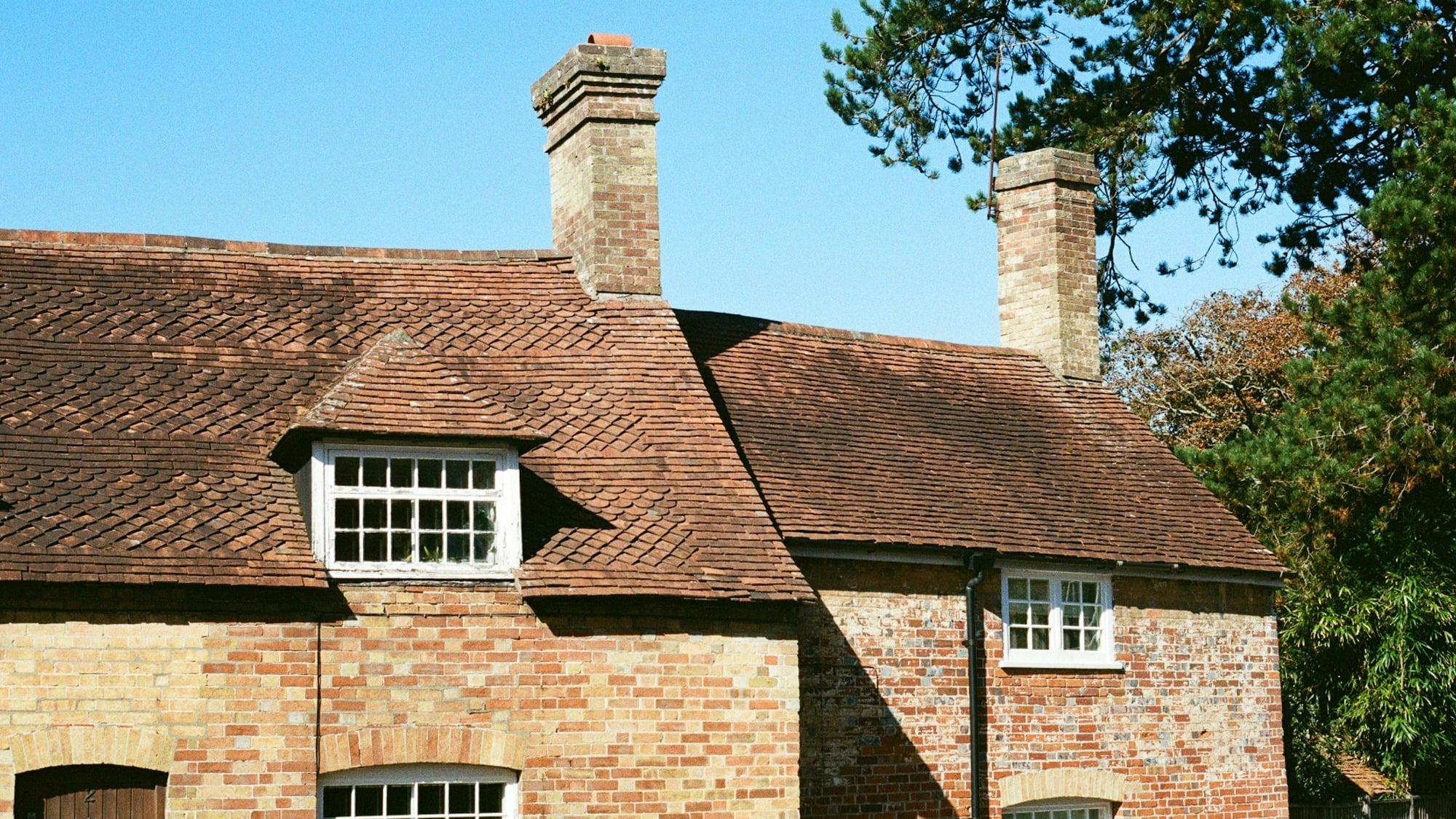Brick chimney on tiled roof