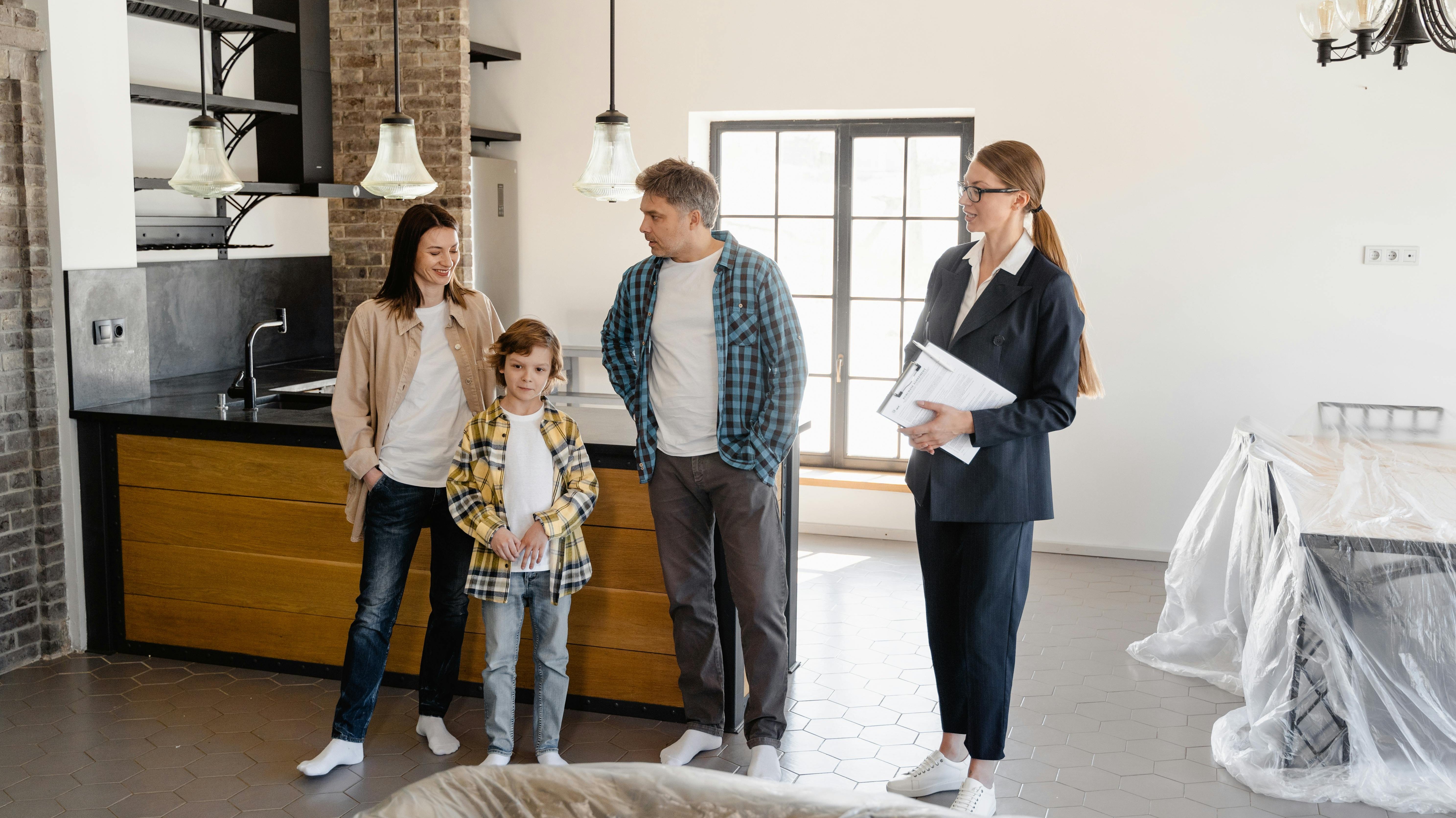 Happy family in front of their new home