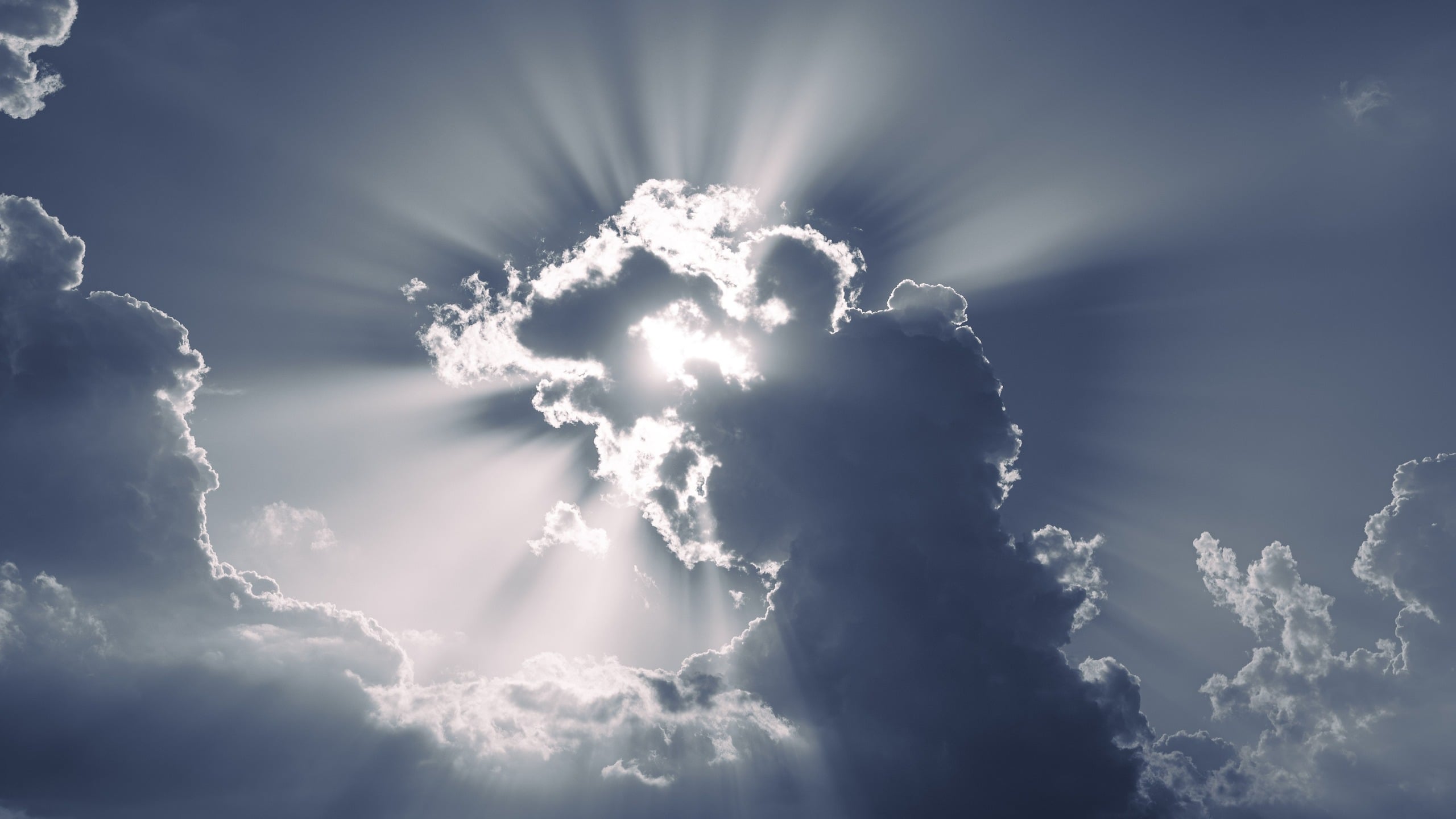 Light breaking through clouds at the hour of mercy