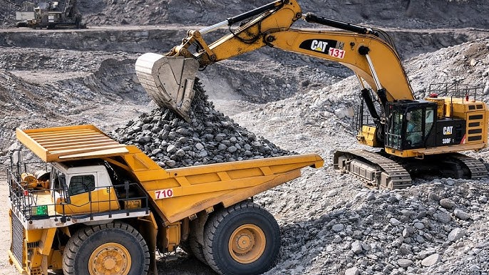 Heavy mining equipment and excavators at an active mining operation