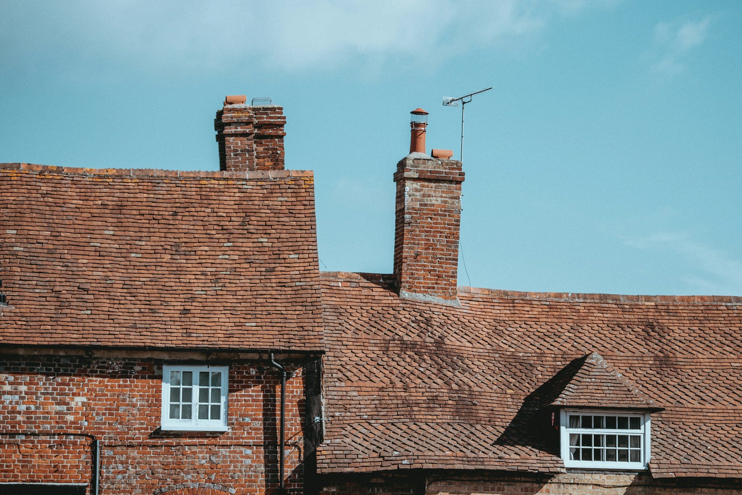 Brick chimneys on a clay tiled roof