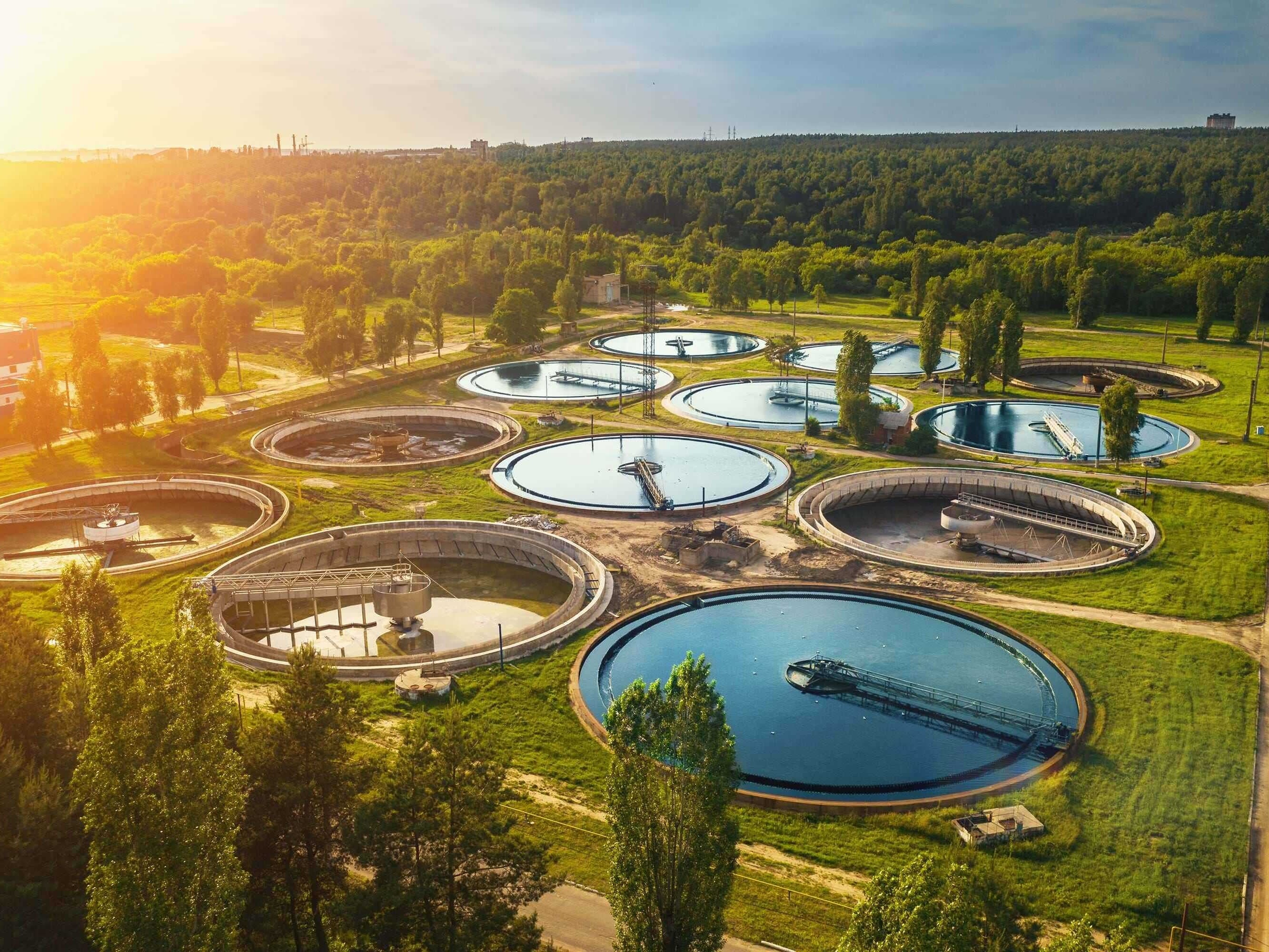 Modern water treatment plant with filtration tanks and sedimentation basins near the Nile