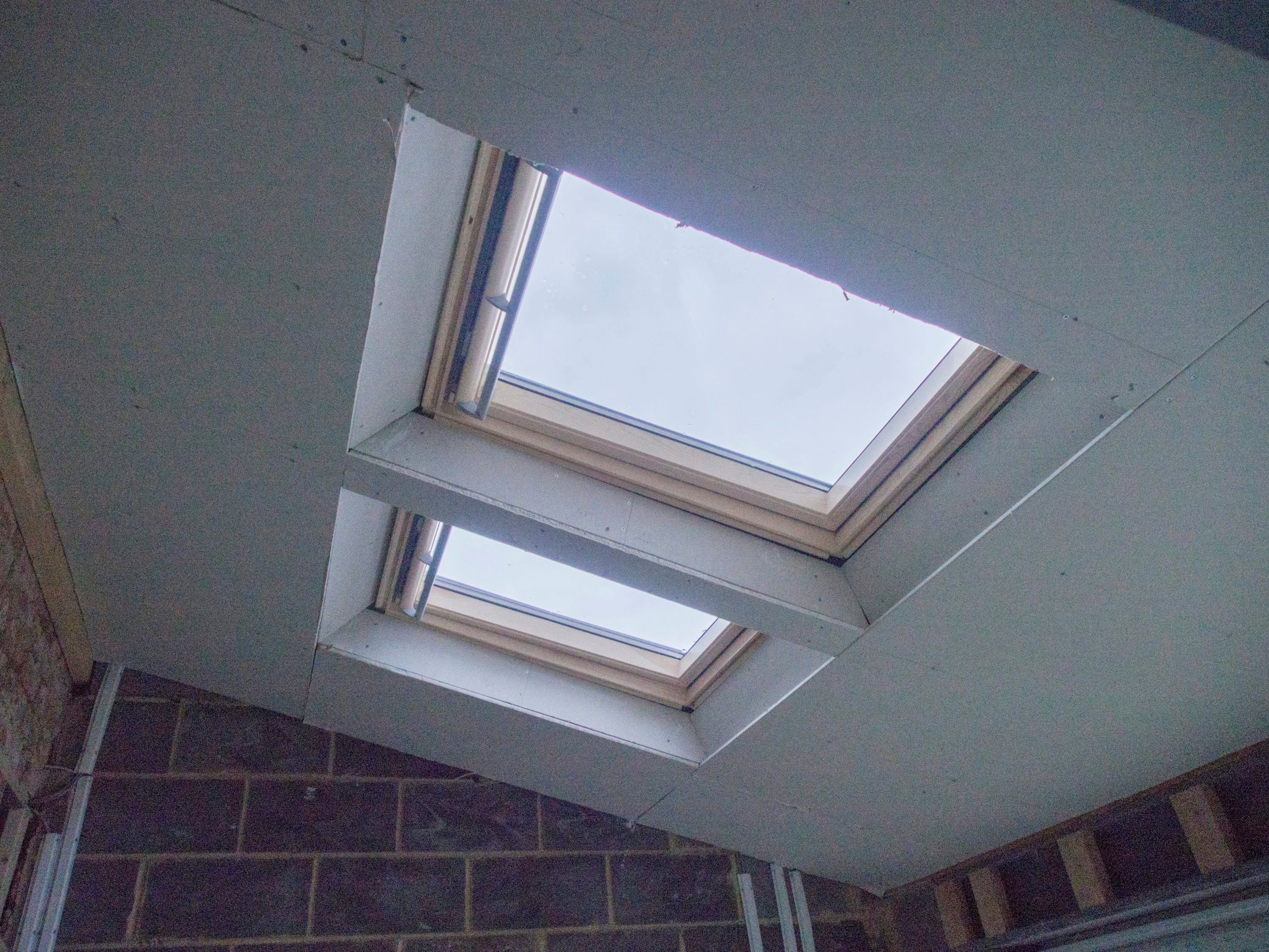 Loft conversion with skylight and brick wall