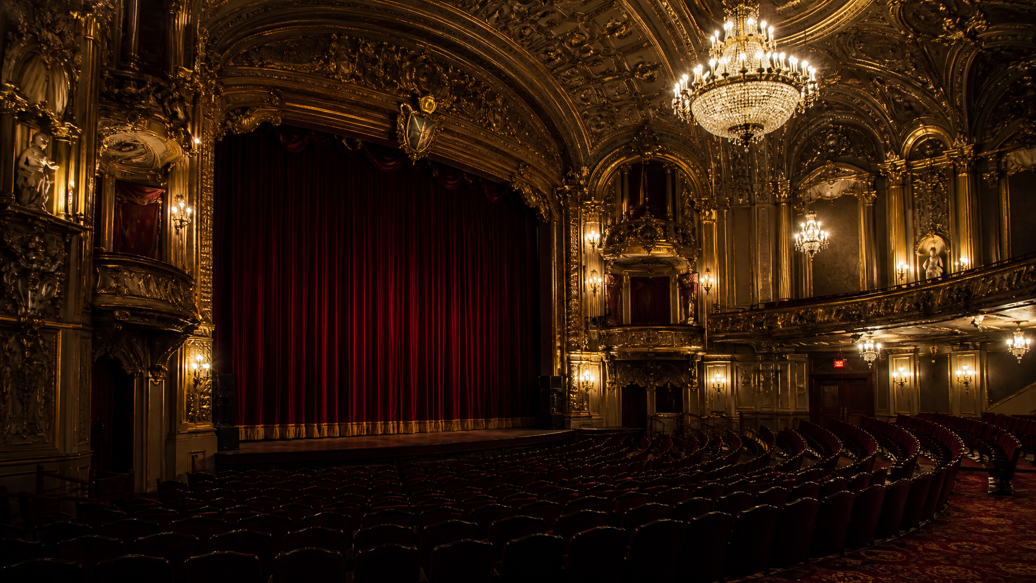 Elegant 1920s period cinema with baroque architecture and crystal chandeliers