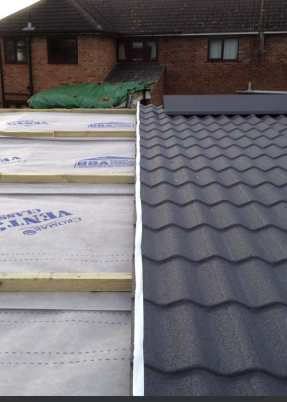 Park home exterior with new cladding panels fitted around windows and roofline
