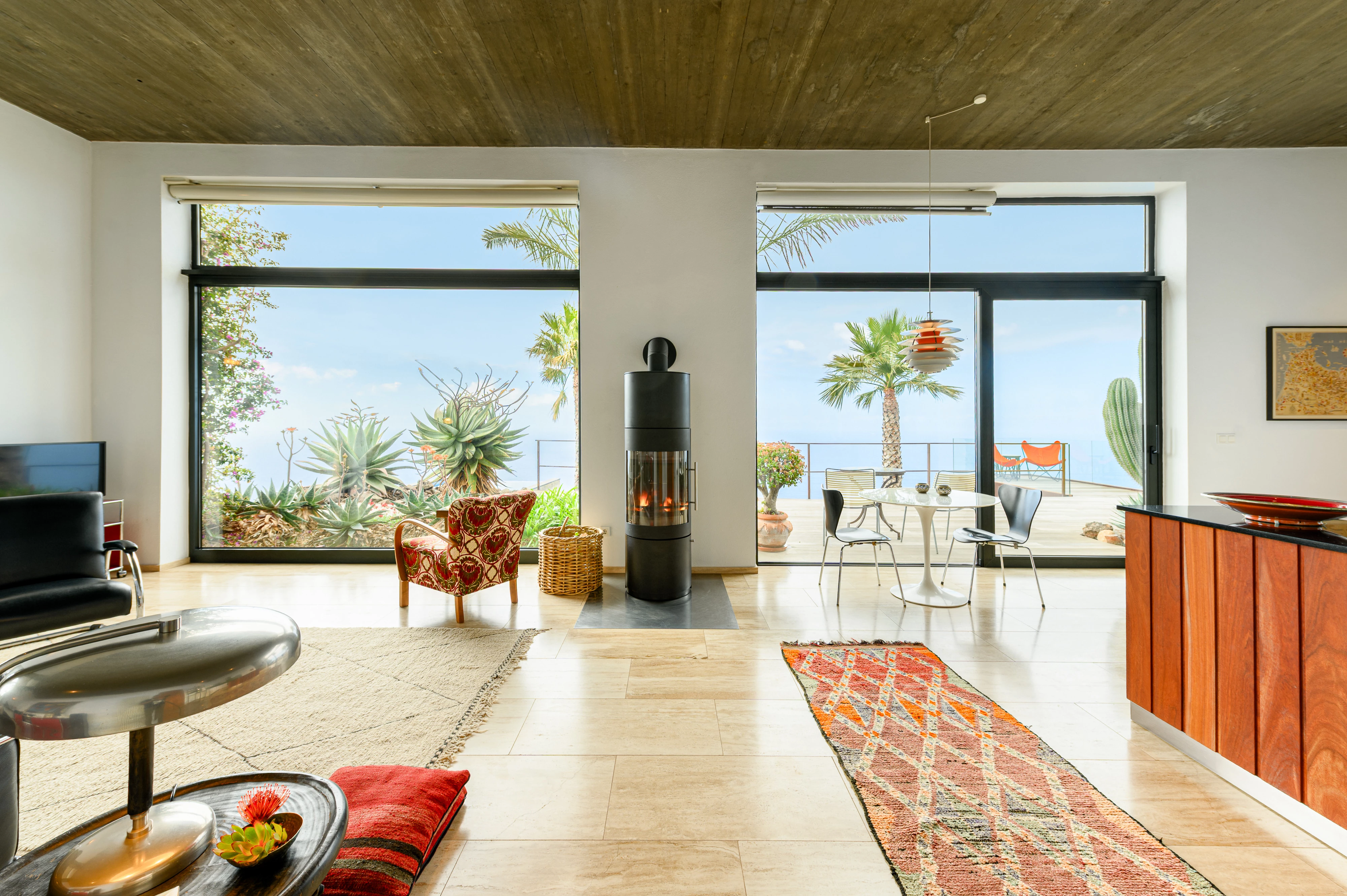 Bright living and kitchen area with panoramic sea-view windows