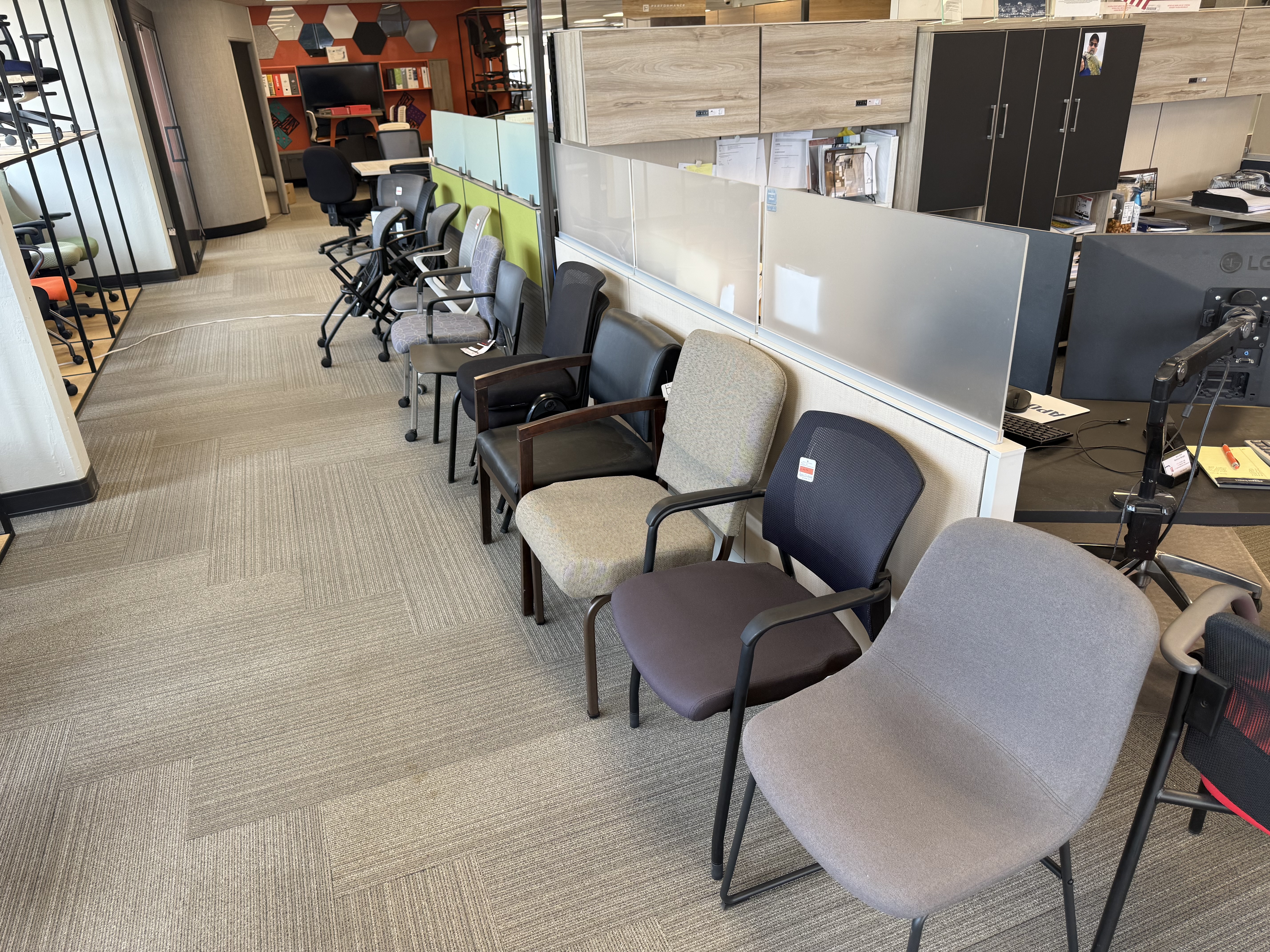 Guest and task chair selection displayed along the showroom hallway