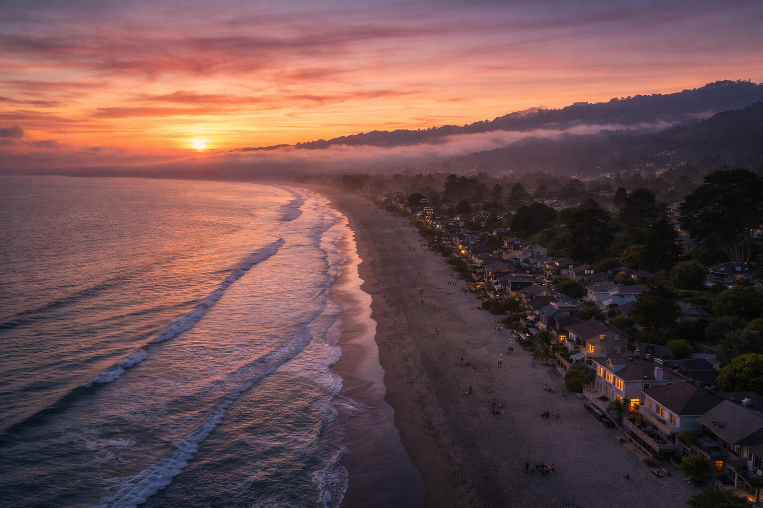 Stinson Beach coastline at sunset with fog rolling over the Marin hills