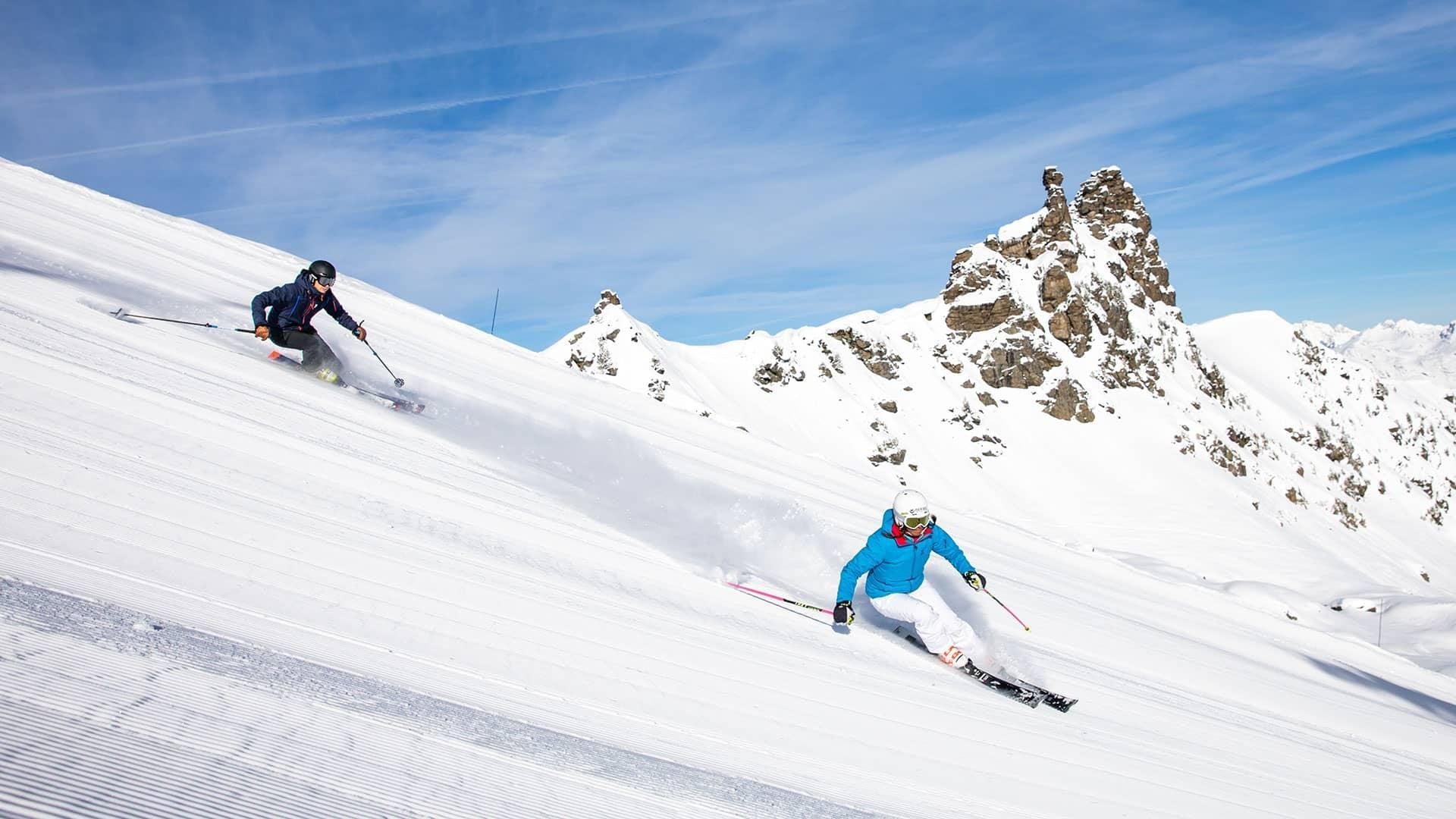 Skiers on the slopes above Méribel with Les 3 Vallées panorama