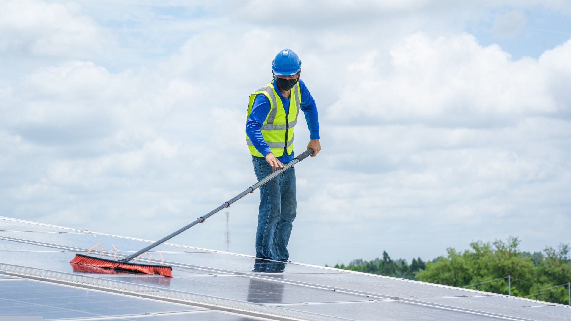 Professional solar panel cleaning on residential roof