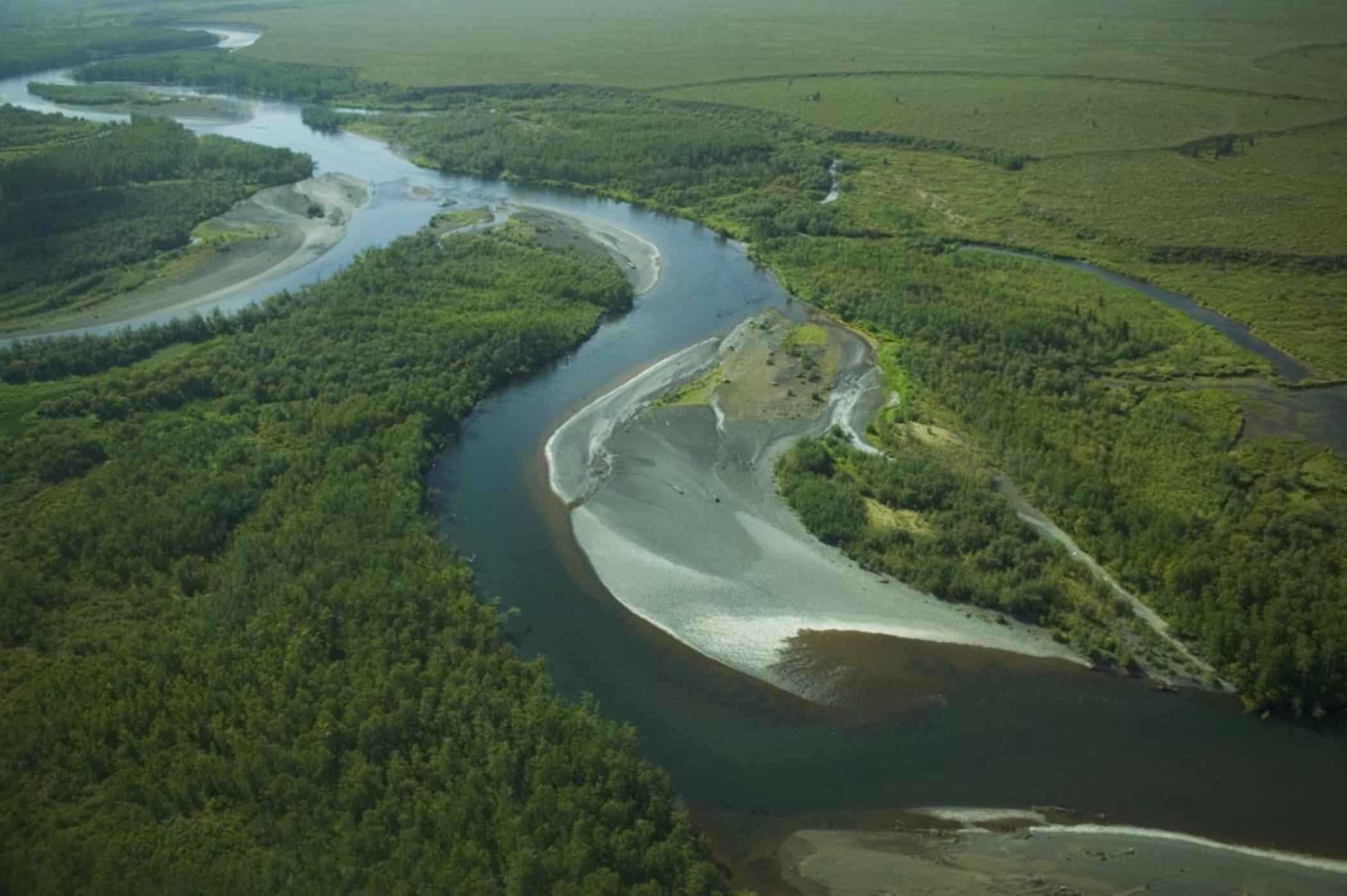 A meandering river winding through a green valley