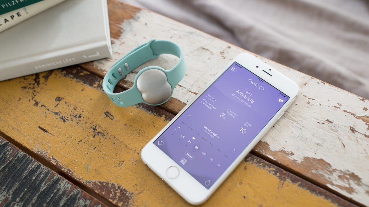 Woman wearing fertility tracking device while sleeping