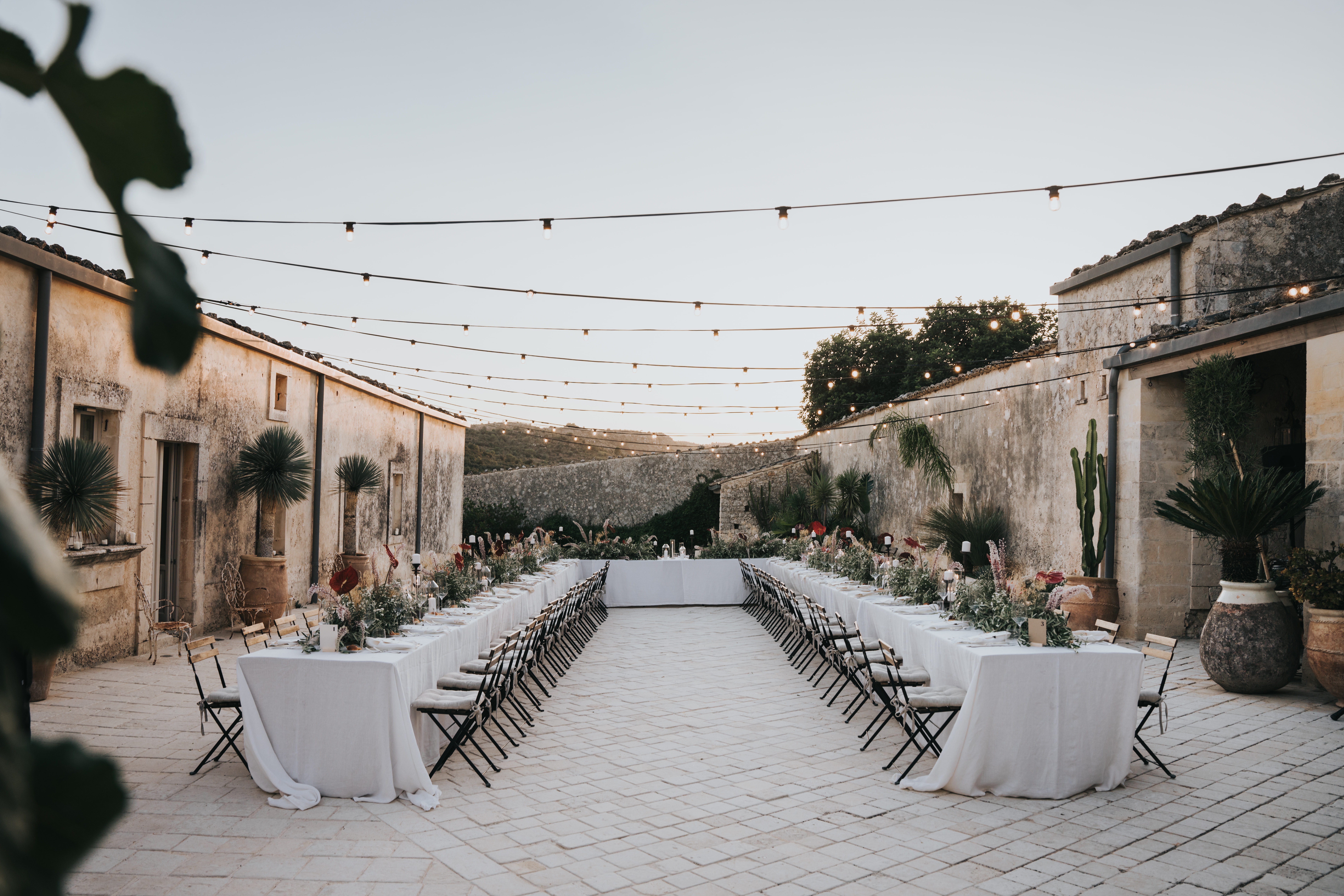 Romantic wedding reception in an elegant Sicilian courtyard at dusk