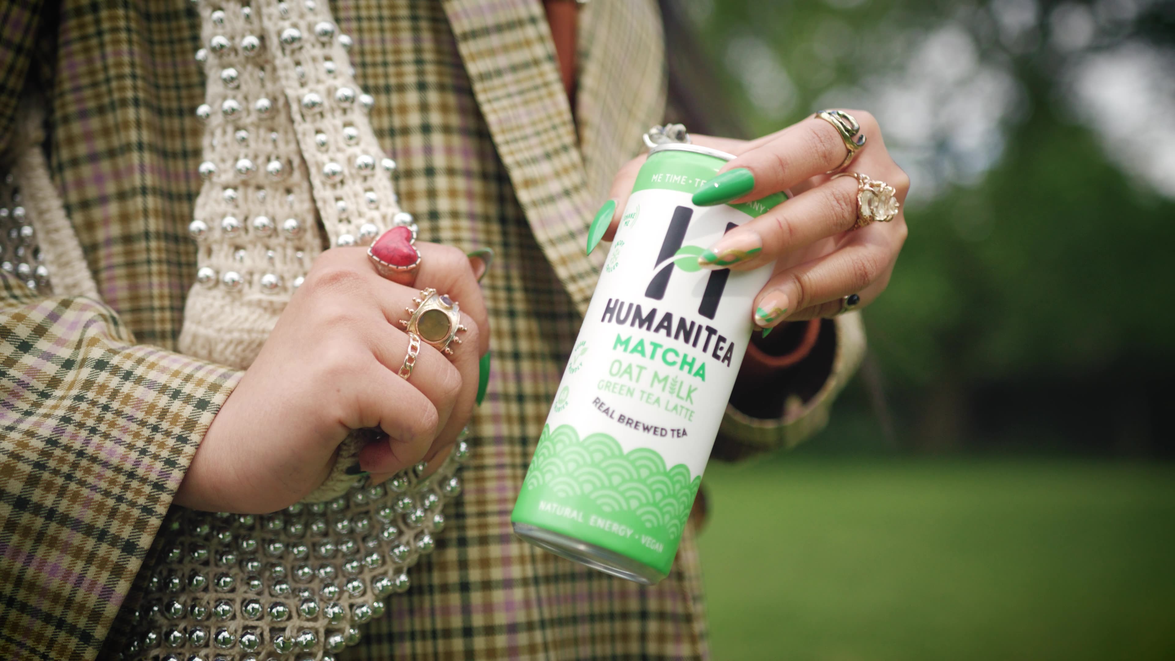 HumaniTea matcha oat milk latte can held in hand
