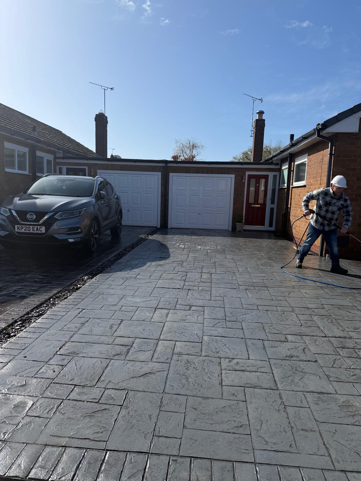 UK driveway with operative preparing to start pressure washing