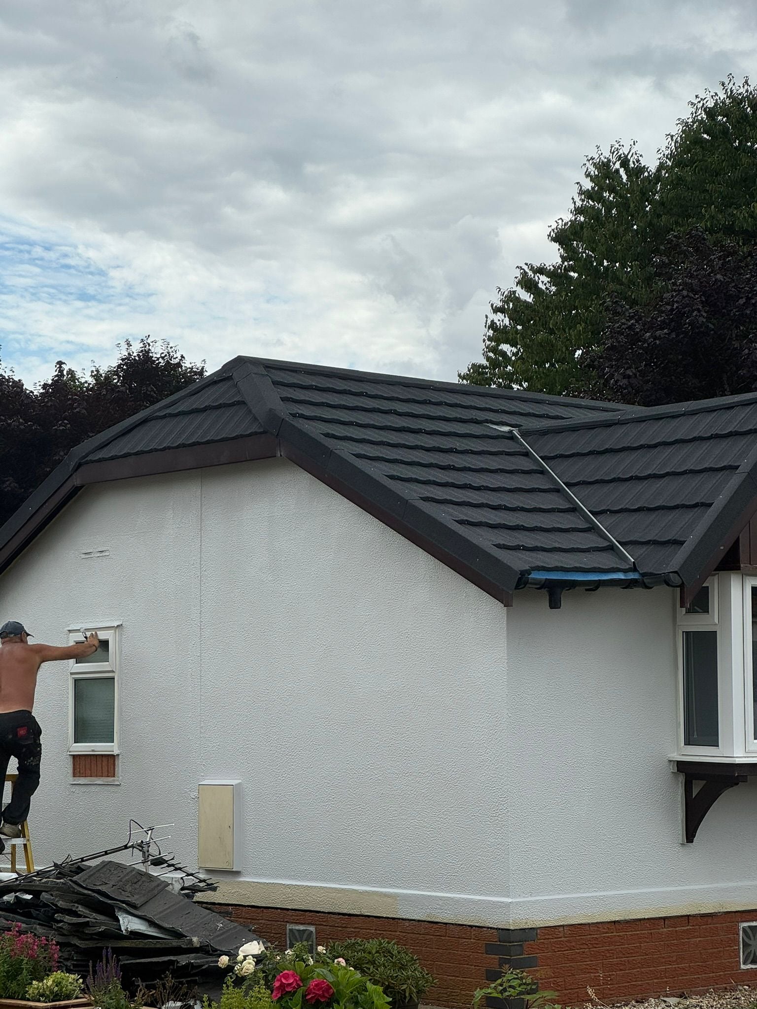 Park home with new roof tiles and exterior painting in progress