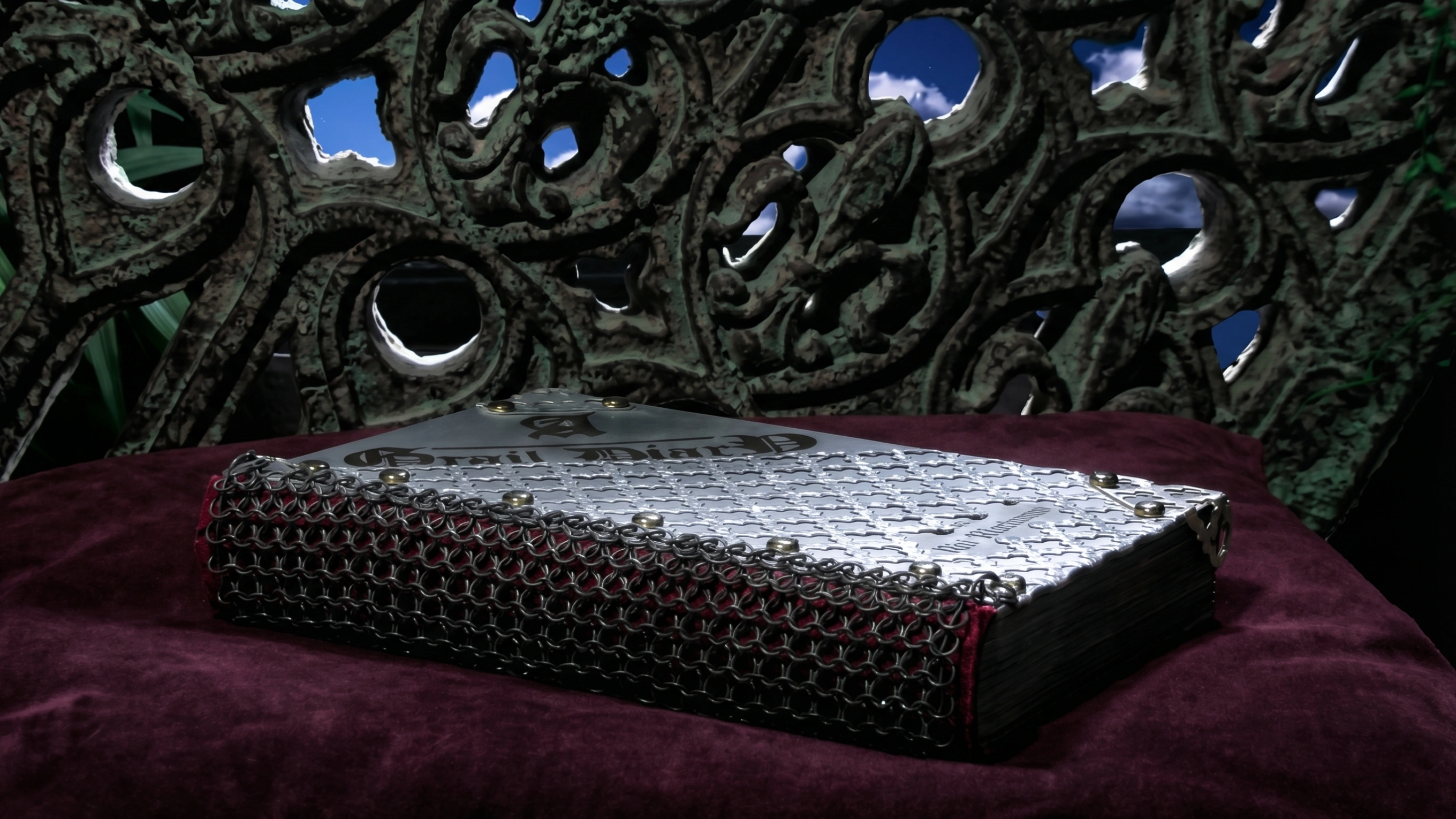 The Grail Diary — chainmaille-armored journal with silver plate cover and riveted details, resting on velvet