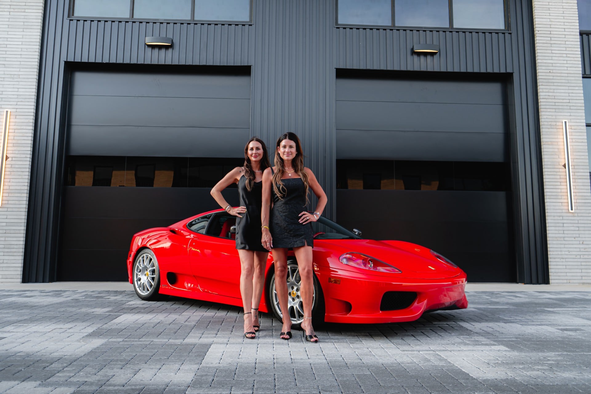 The Supercar Sisters standing in front of the showroom
