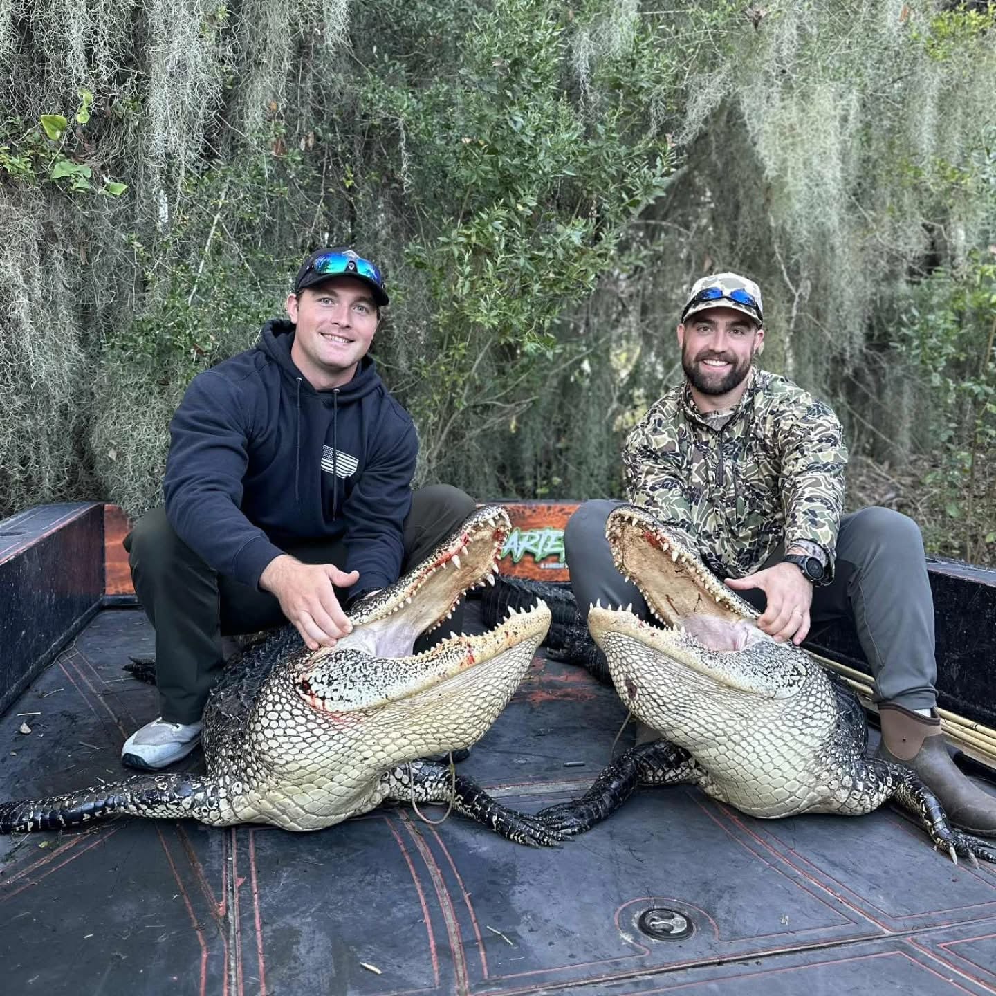 Bayou Bowfishing branded boat on the water at sunset