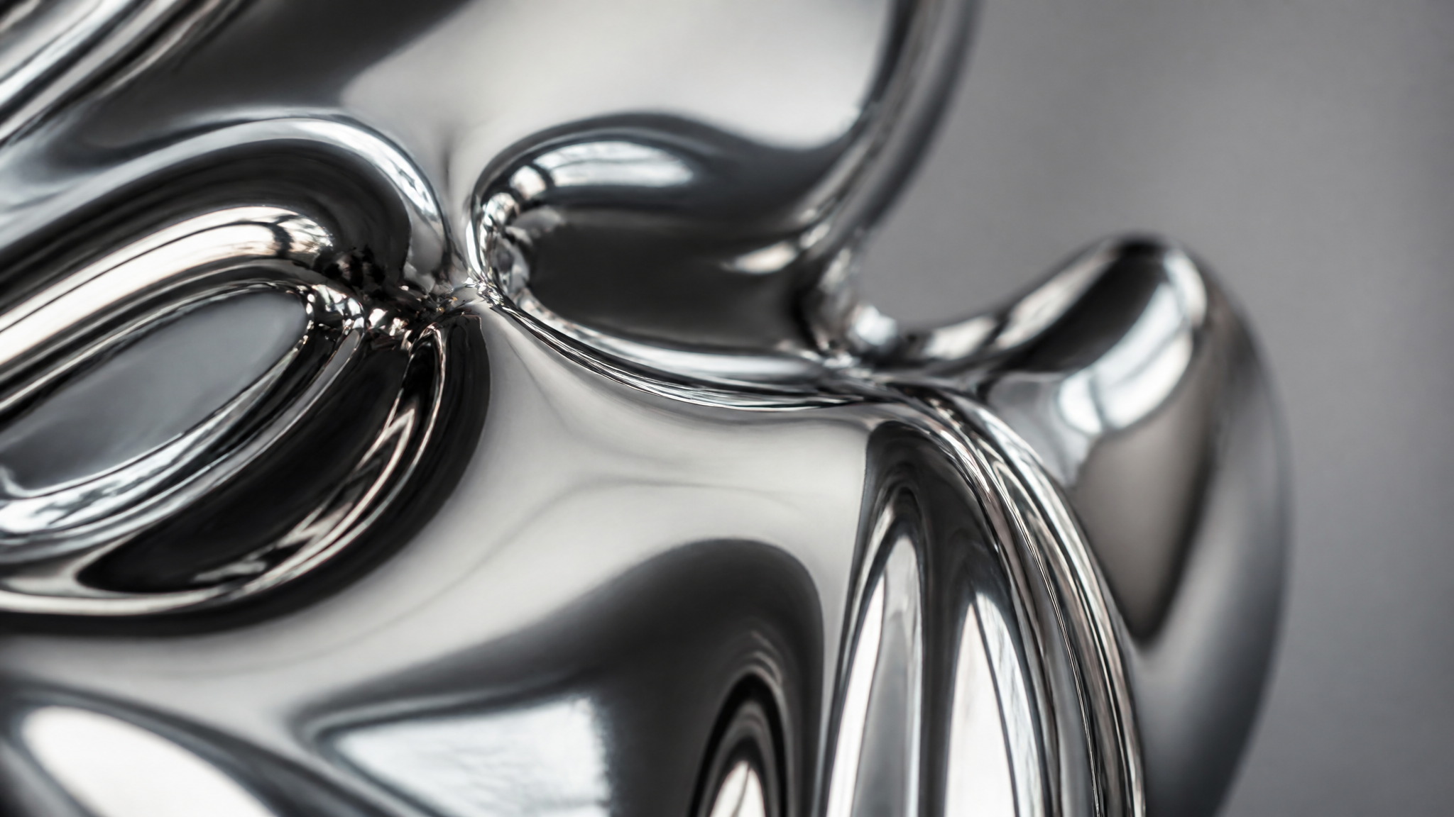 Extreme close-up of glossy liquid-metal chrome surface reflections