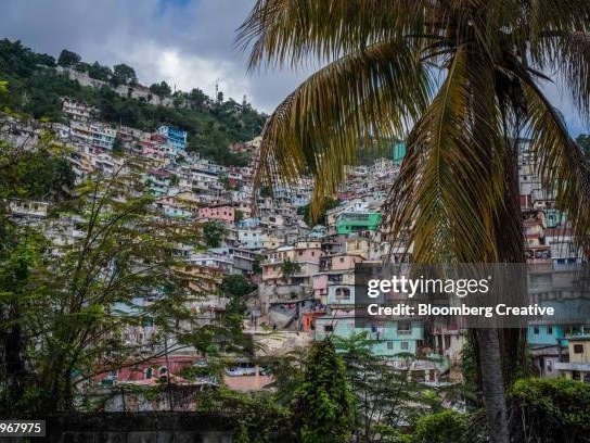 Colorful Haitian landscape with buildings and palm trees