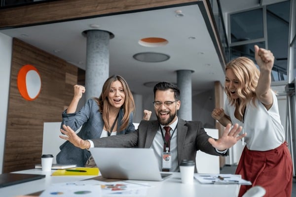 Business team celebrating growth and success together