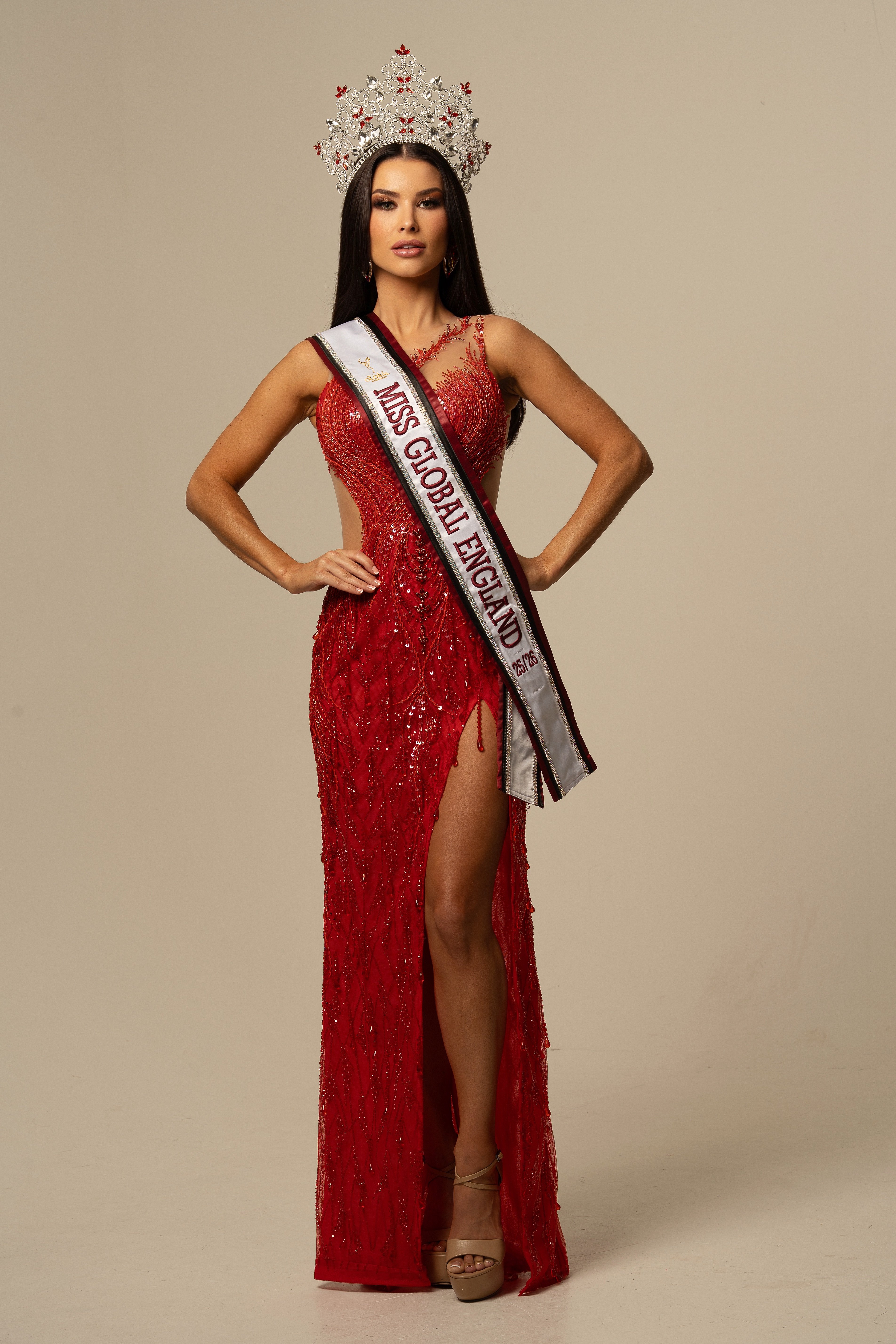 Miss Global England in red gown with crown and sash