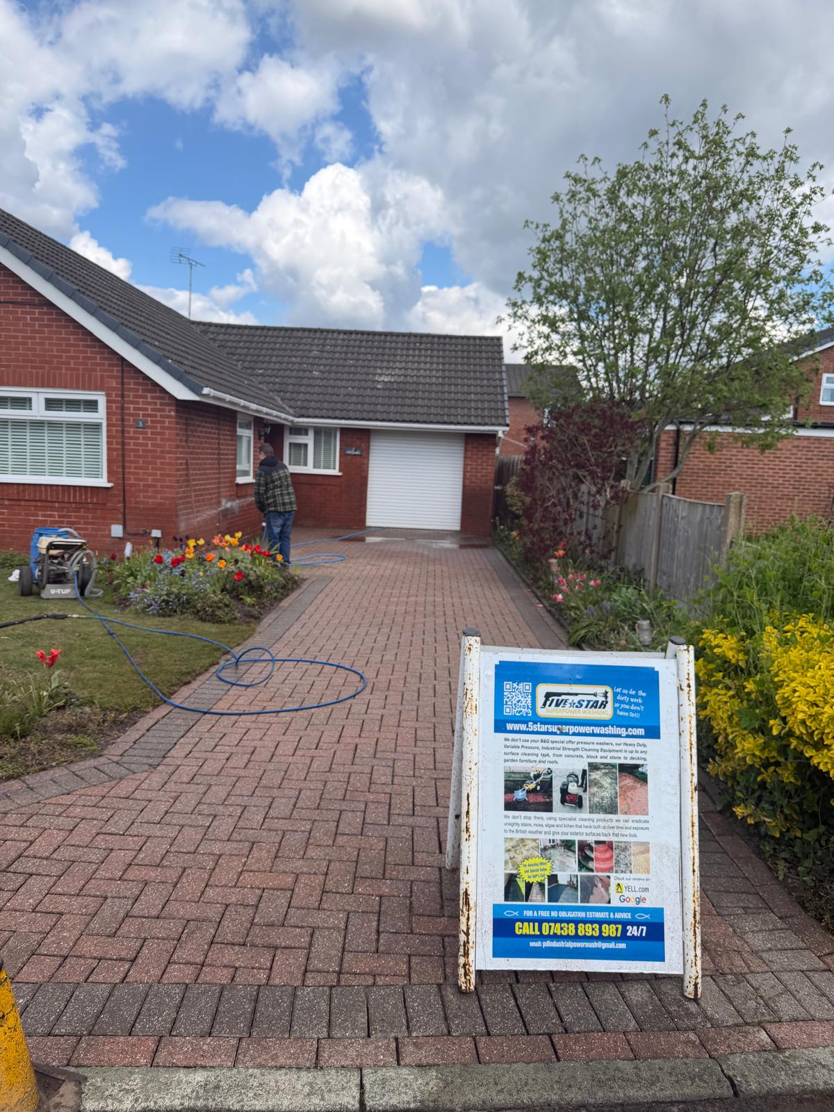 Block-paved UK driveway with spring flowers and 5 Star branded sign